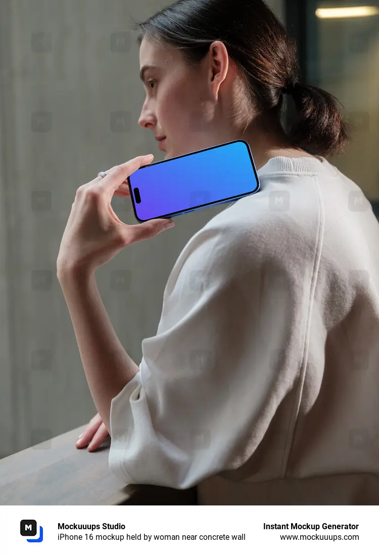 iPhone 16 mockup held by woman near concrete wall