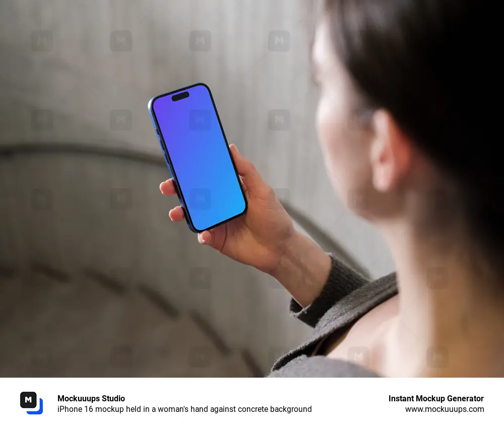 iPhone 16 mockup held in a woman's hand against concrete background