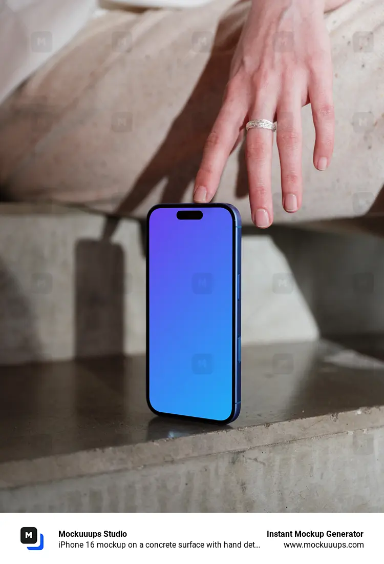 iPhone 16 mockup on a concrete surface with hand detail