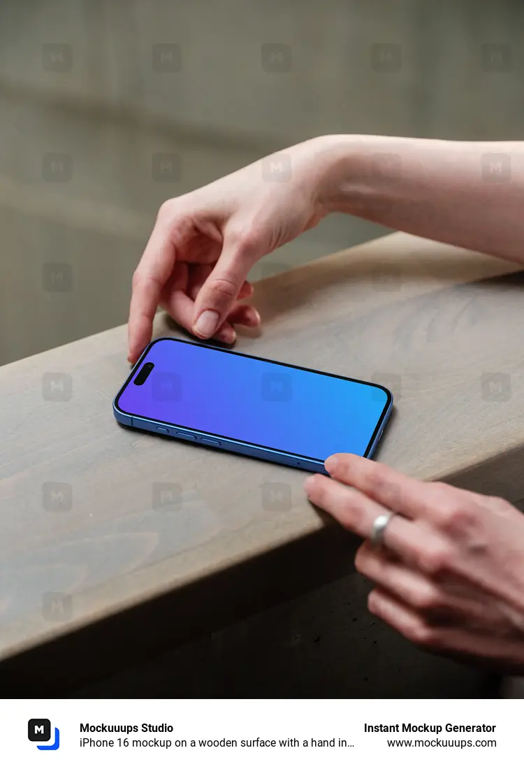 iPhone 16 mockup on a wooden surface with a hand interacting