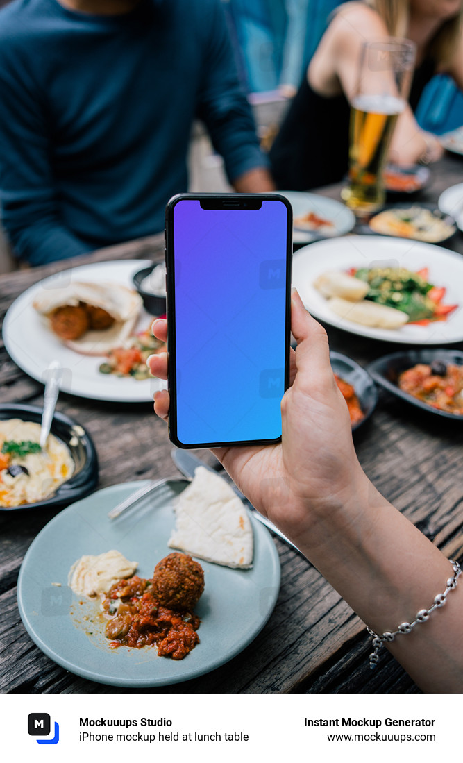 iPhone mockup held at lunch table