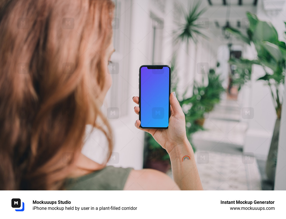 iPhone mockup held by user in a plant-filled corridor