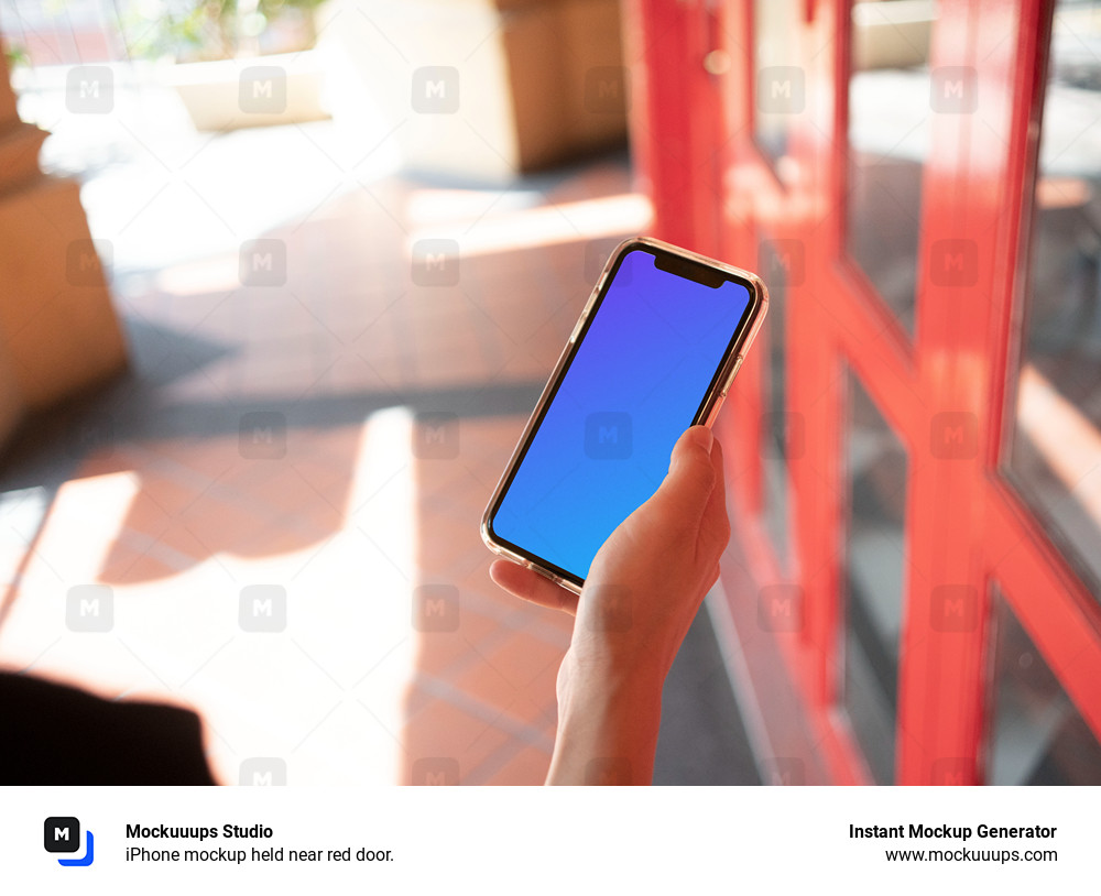 iPhone mockup held near red door.