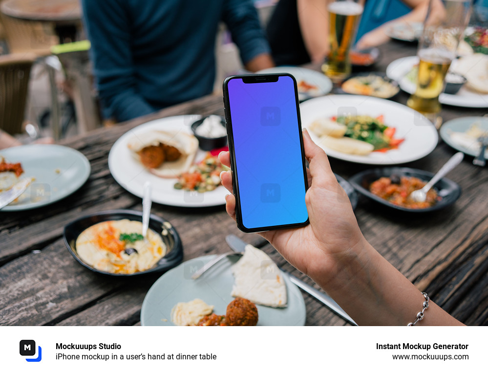 iPhone mockup in a user’s hand at dinner table