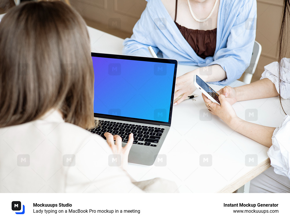 Lady typing on a MacBook Pro mockup in a meeting