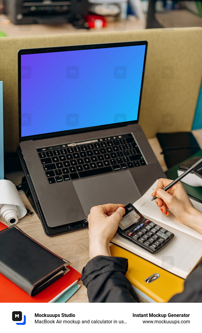 MacBook Air mockup and calculator in use by a man