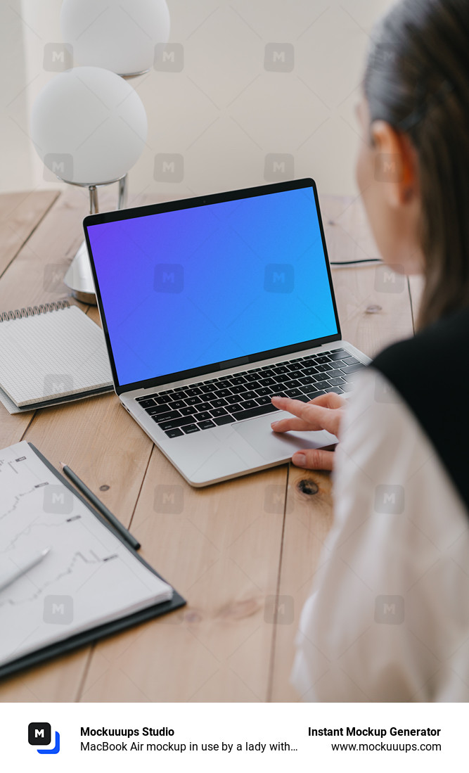 MacBook Air mockup in use by a lady with a notepad at the side