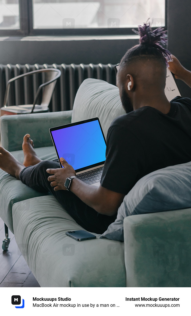 MacBook Air mockup in use by a man on a couch