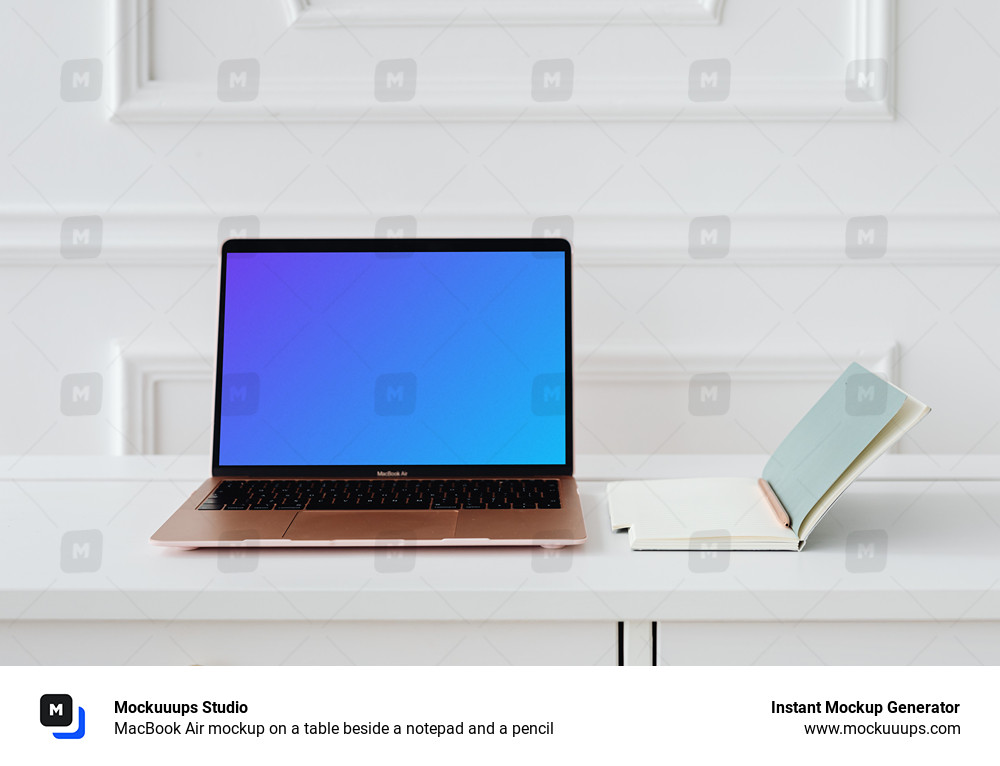 MacBook Air mockup on a table beside a notepad and a pencil