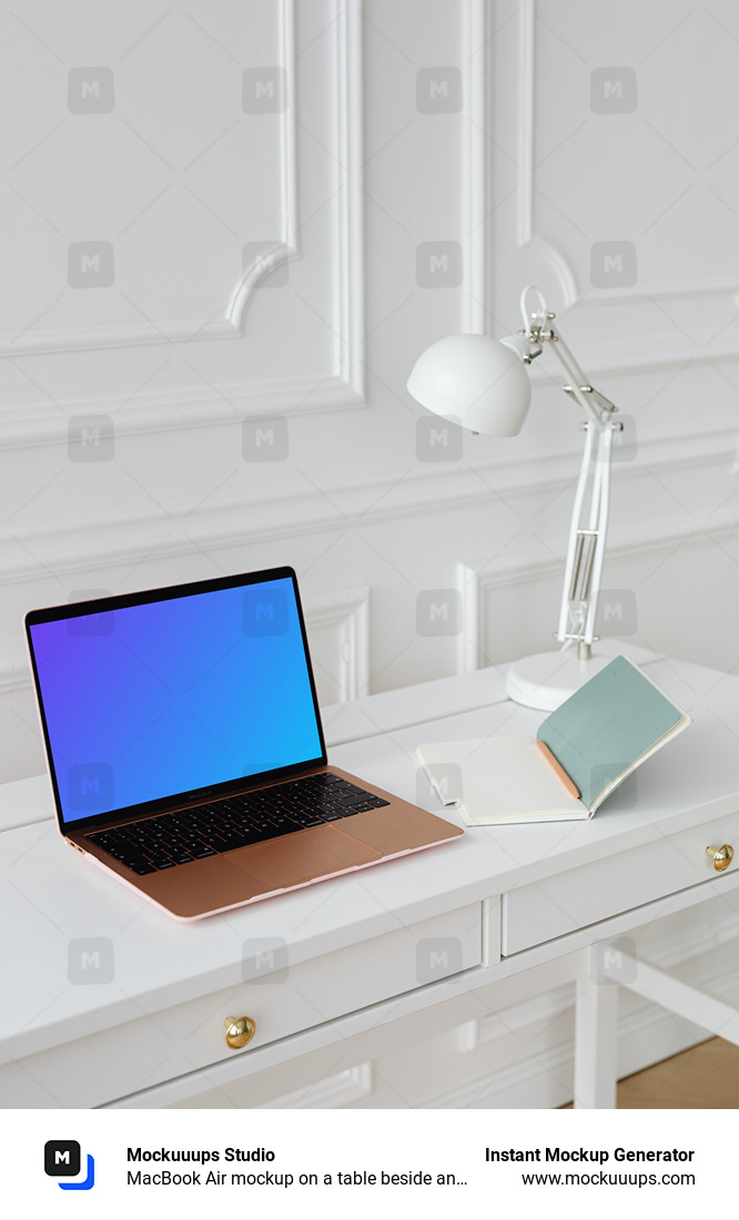 MacBook Air mockup on a table beside an open notepad  
