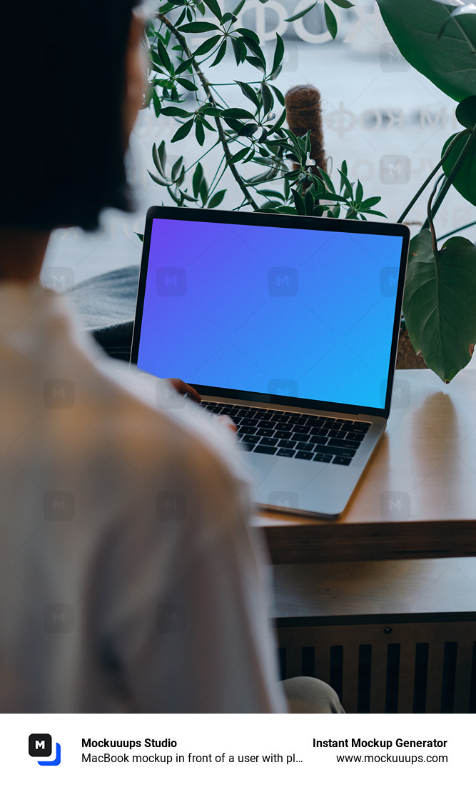 MacBook mockup in front of a user with plants in the background