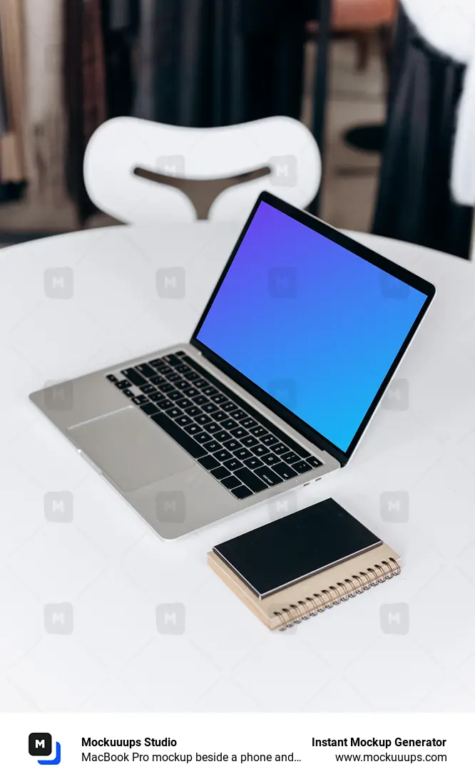 MacBook Pro mockup beside a phone and notepad