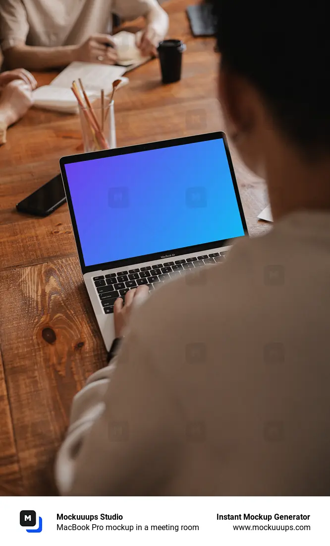 MacBook Pro mockup in a meeting room