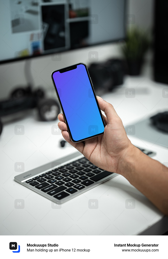 Man holding up an iPhone 12 mockup