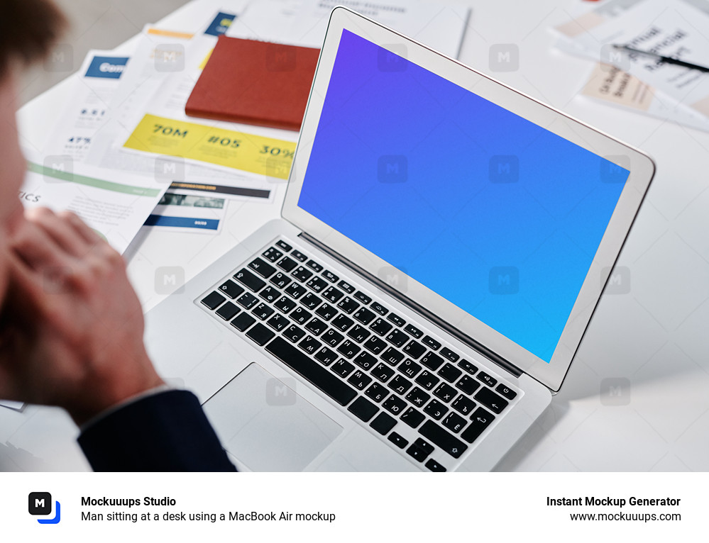 Man sitting at a desk using a MacBook Air mockup