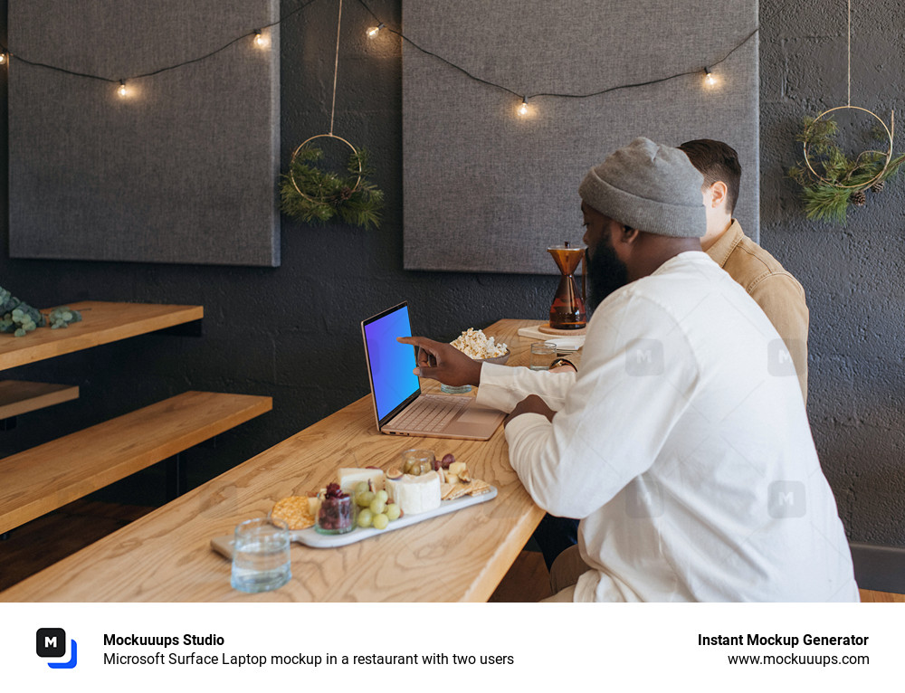 Microsoft Surface Laptop mockup in a restaurant with two users