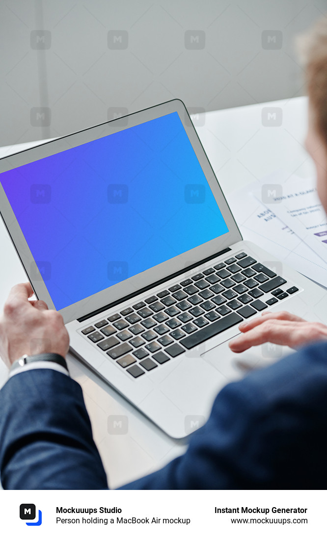 Person holding a MacBook Air mockup