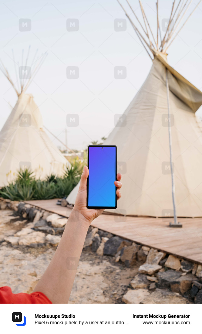 Pixel 6 mockup held by a user at an outdoor campsite