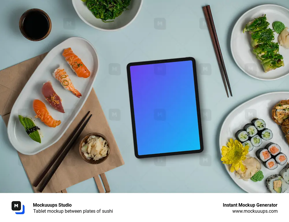 Tablet mockup between plates of sushi