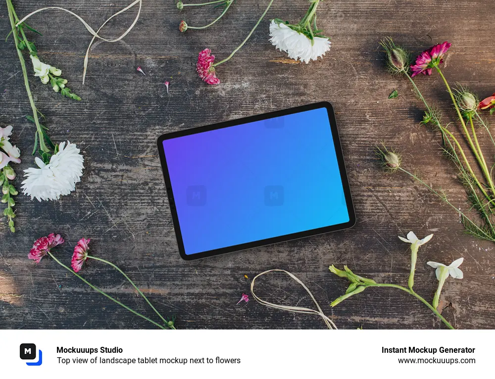 Top view of landscape tablet mockup next to flowers