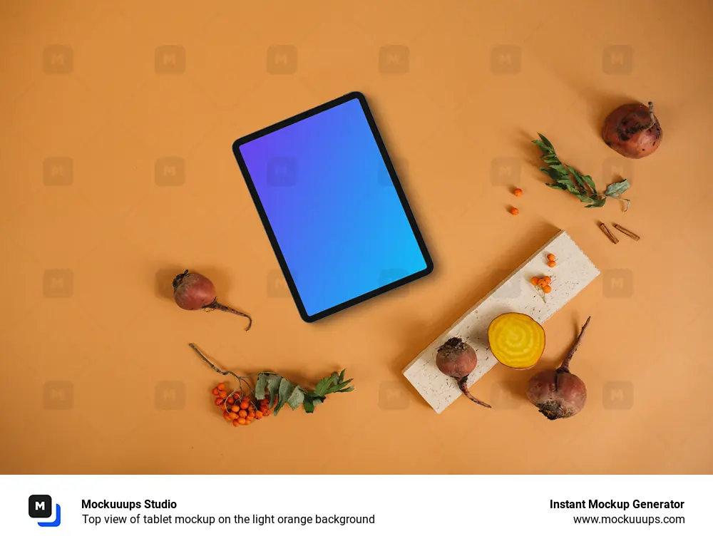 Top view of tablet mockup on the light orange background