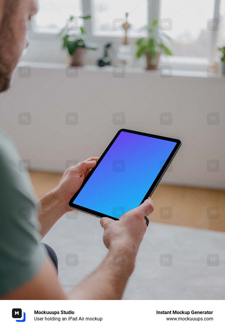 User holding an iPad Air mockup