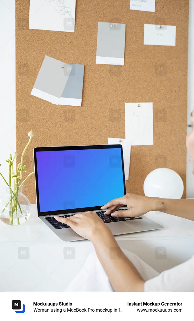 Woman using a MacBook Pro mockup in front of a bulletin board