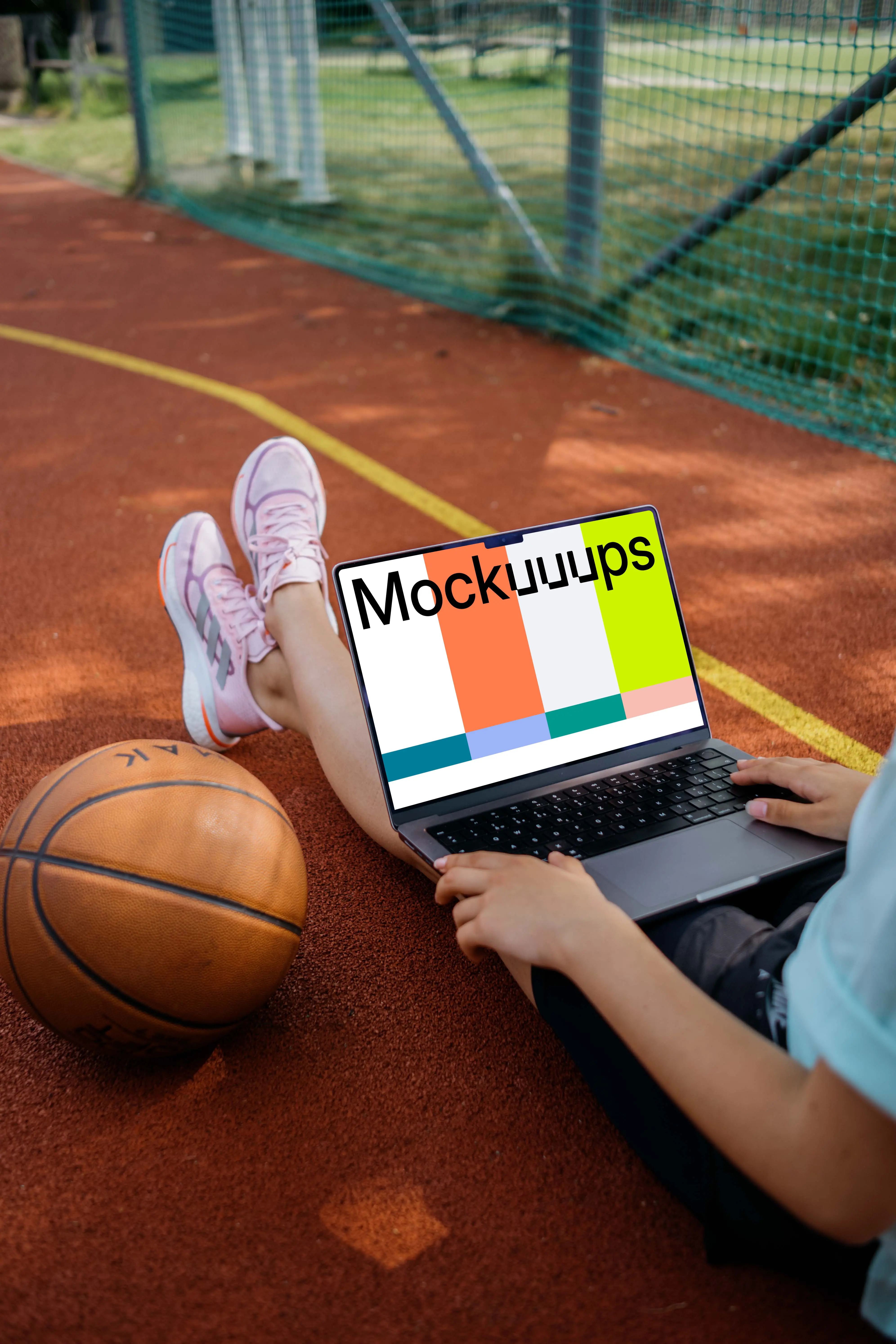 Basketball player checking on laptop mockup