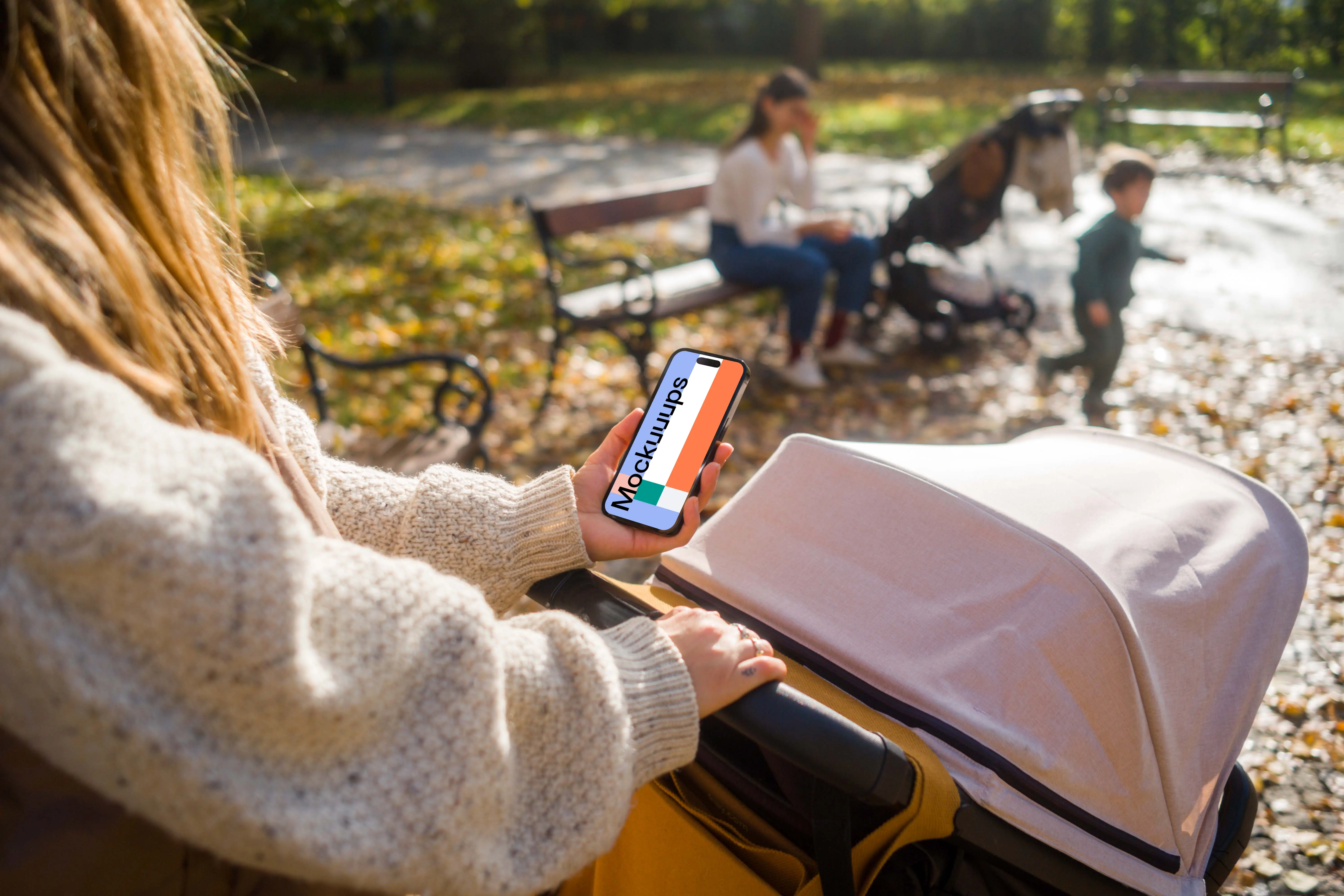 Female holding an iPhone in the park mockup