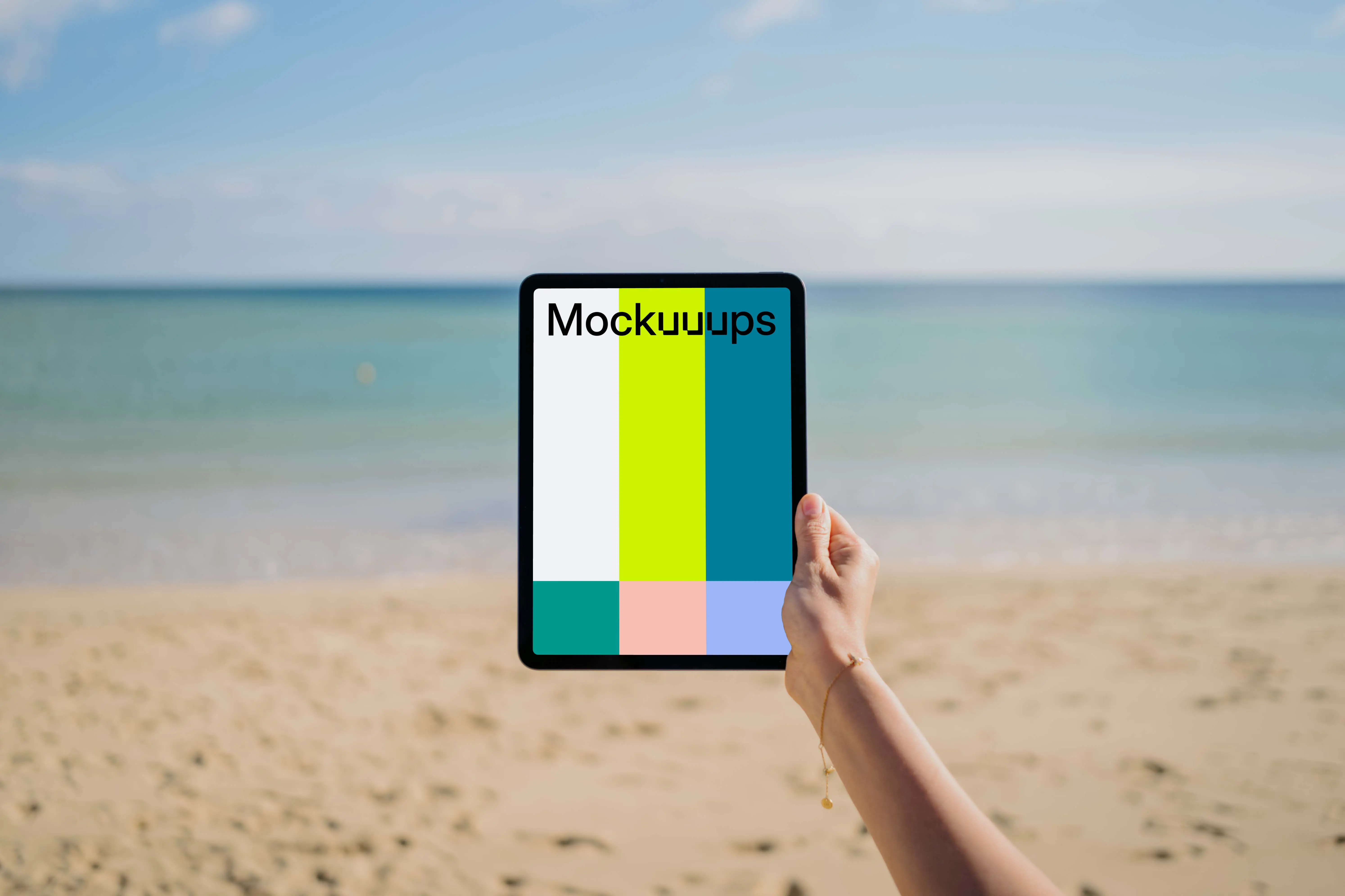 iPad Air mockup held by user at the beach 