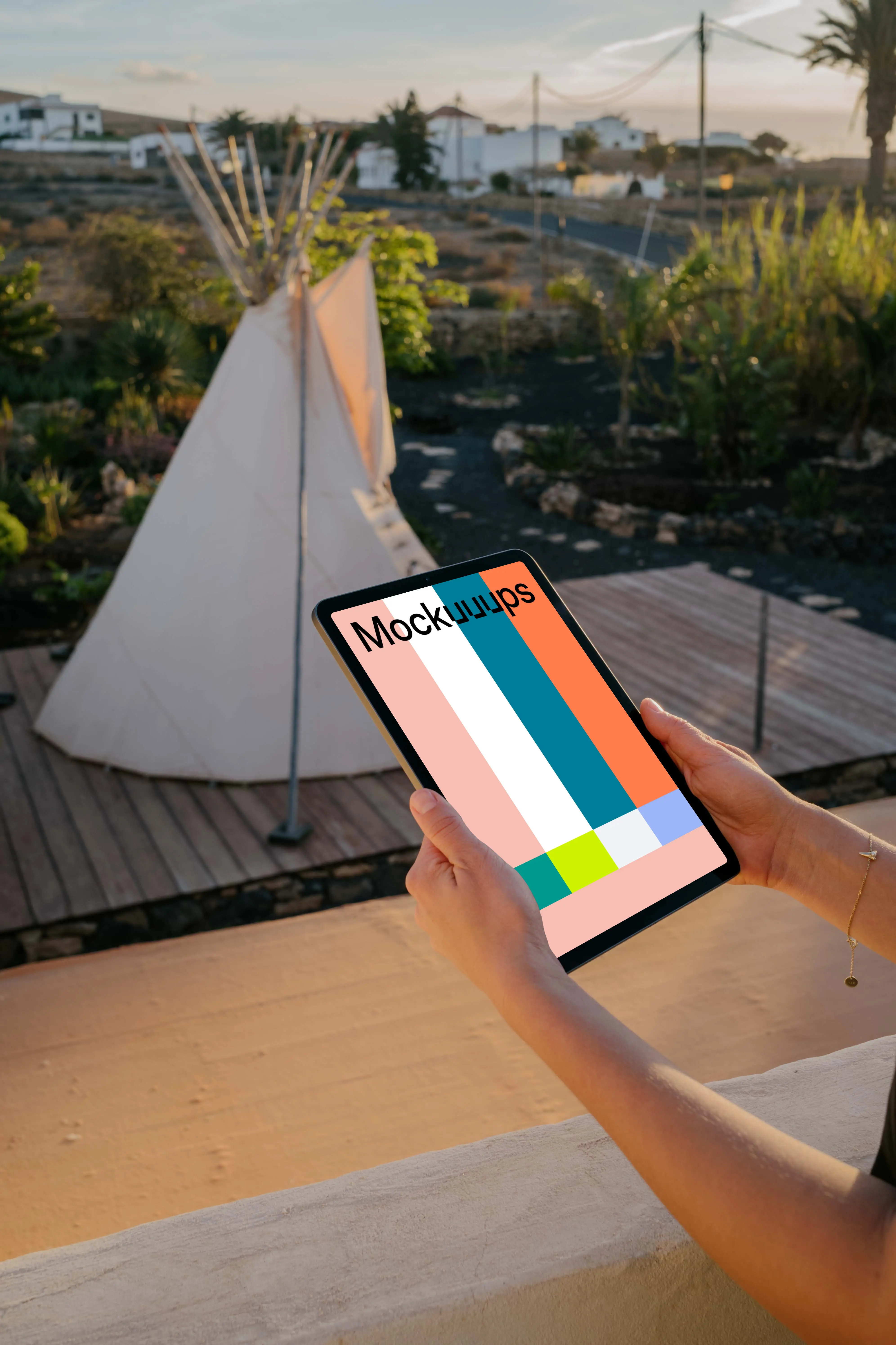 iPad Air mockup held by user on a patio