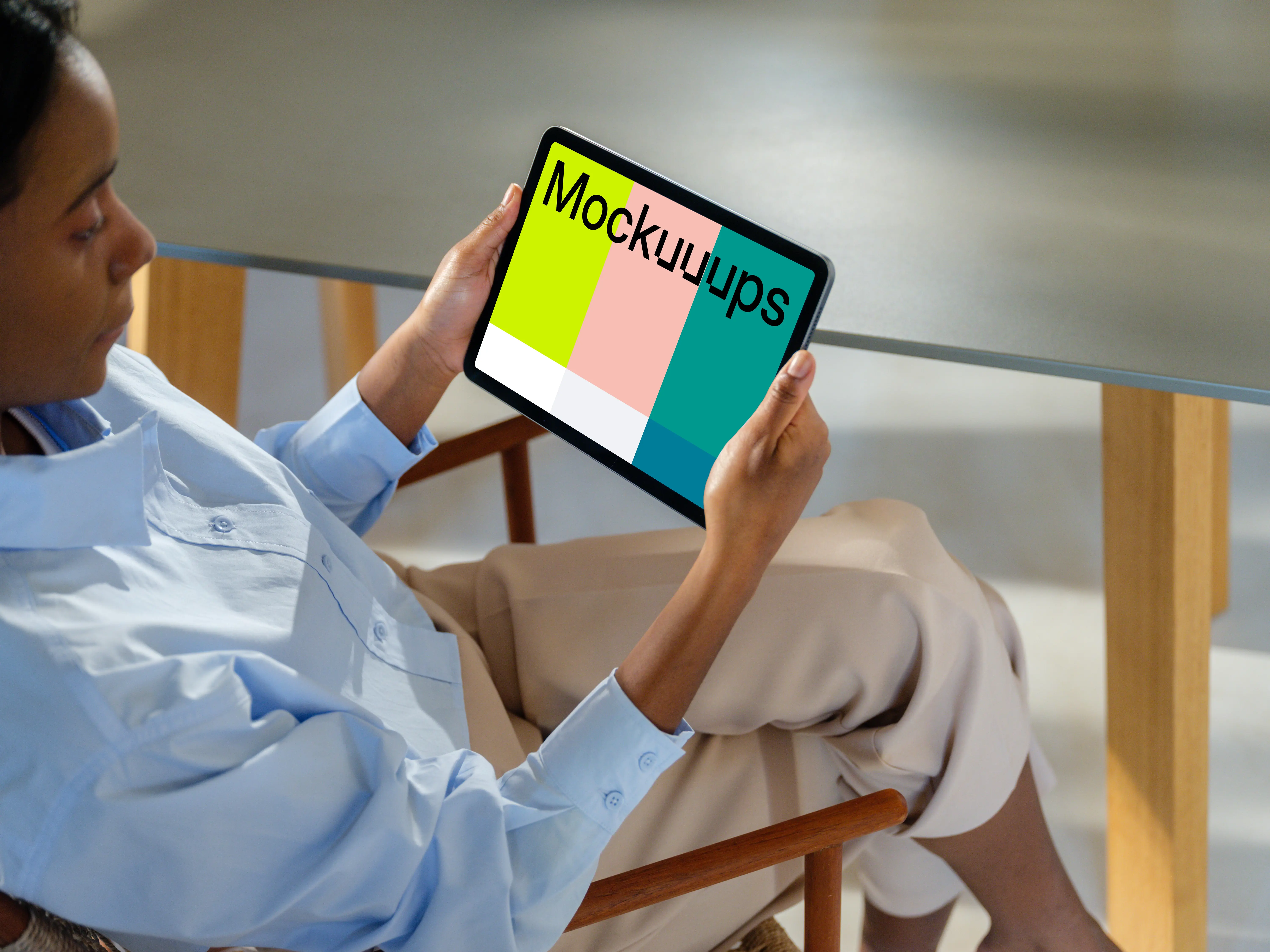 iPad Air mockup in a woman's hand at a modern office