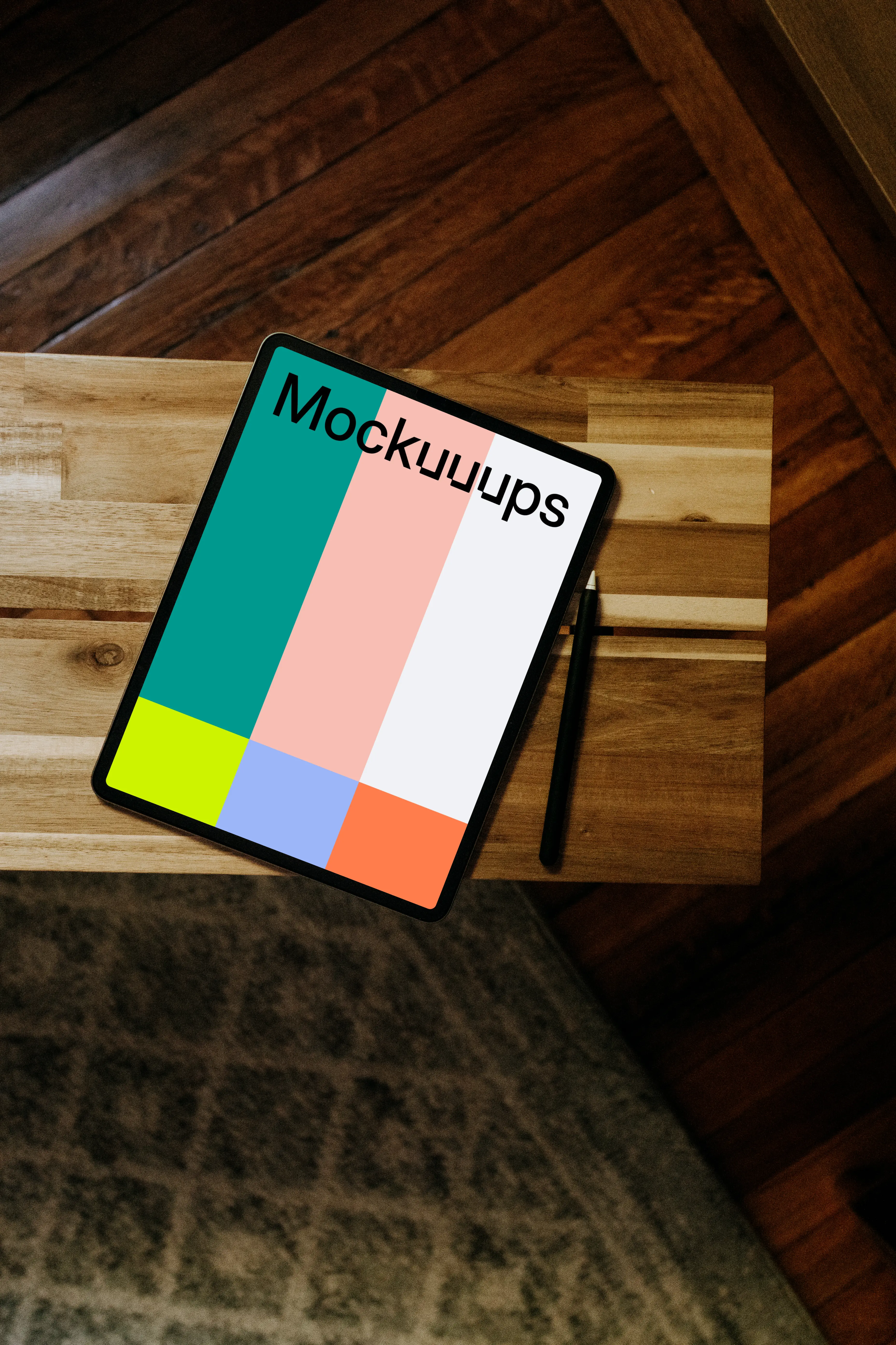 iPad mockup with pen on wooden desk
