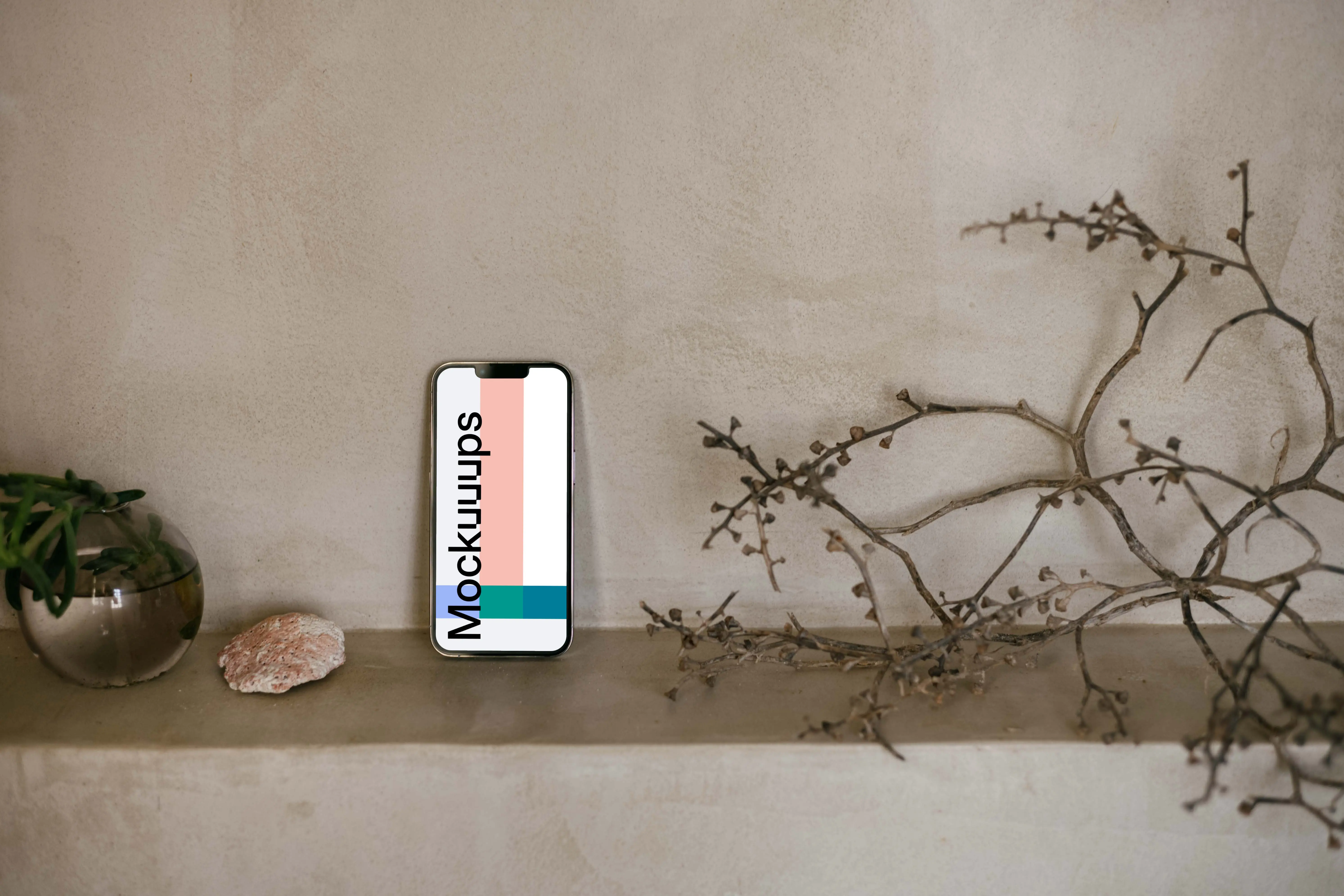 iPhone 13 Pro mockup next to a teapot and shrub