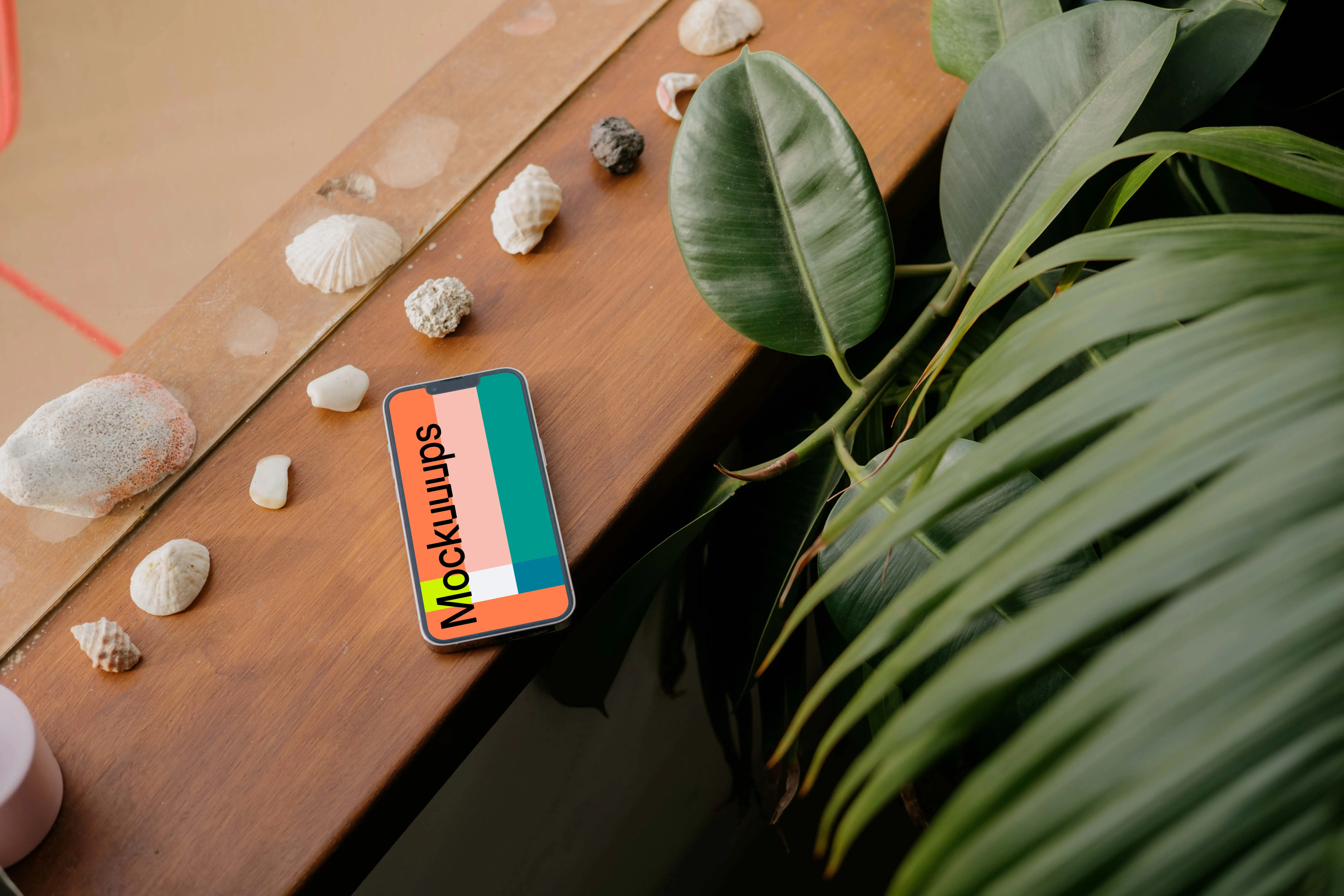  iPhone 13 Pro mockup placed next to seashells