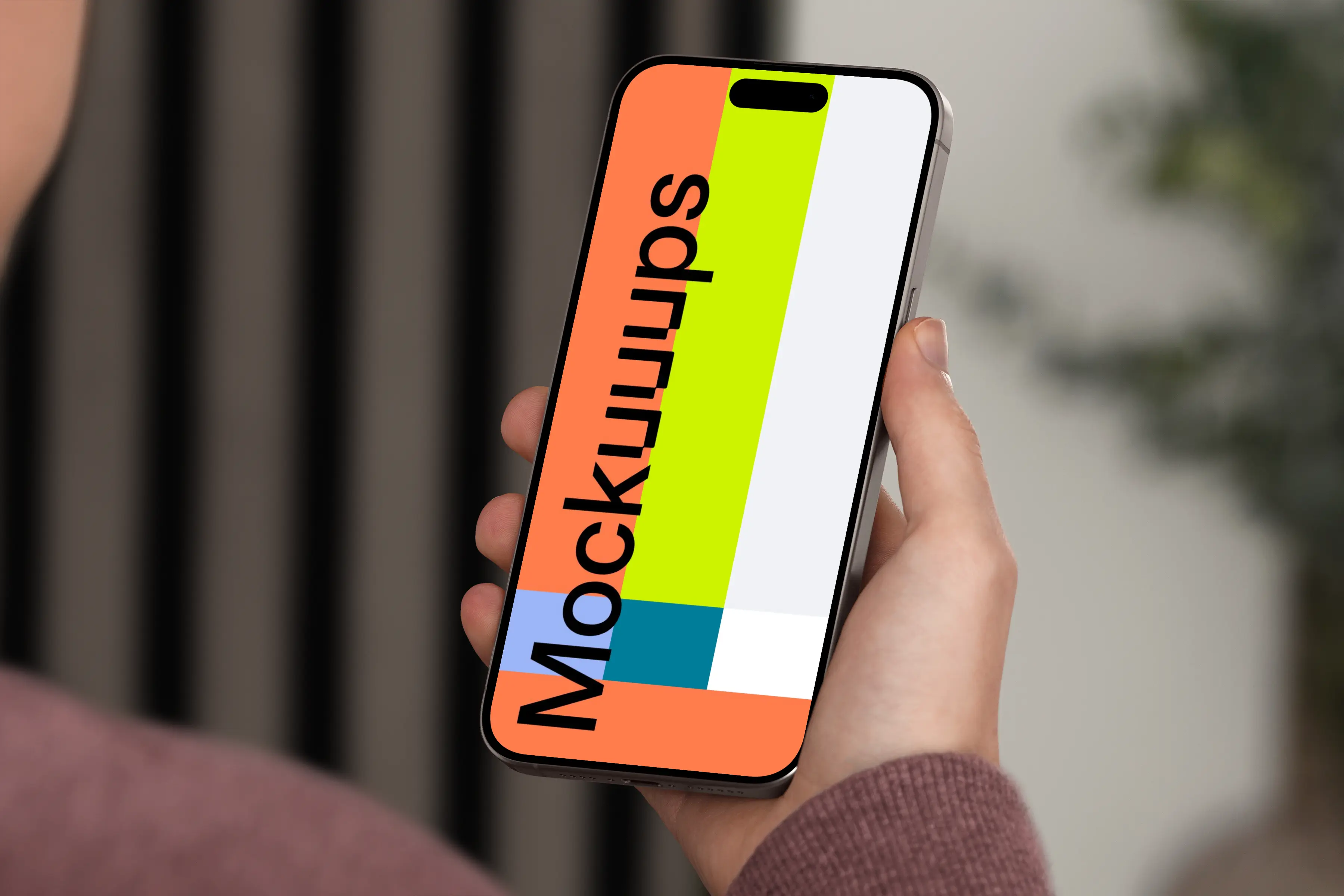 iPhone 15 Pro mockup in a man's hand against an indoor background