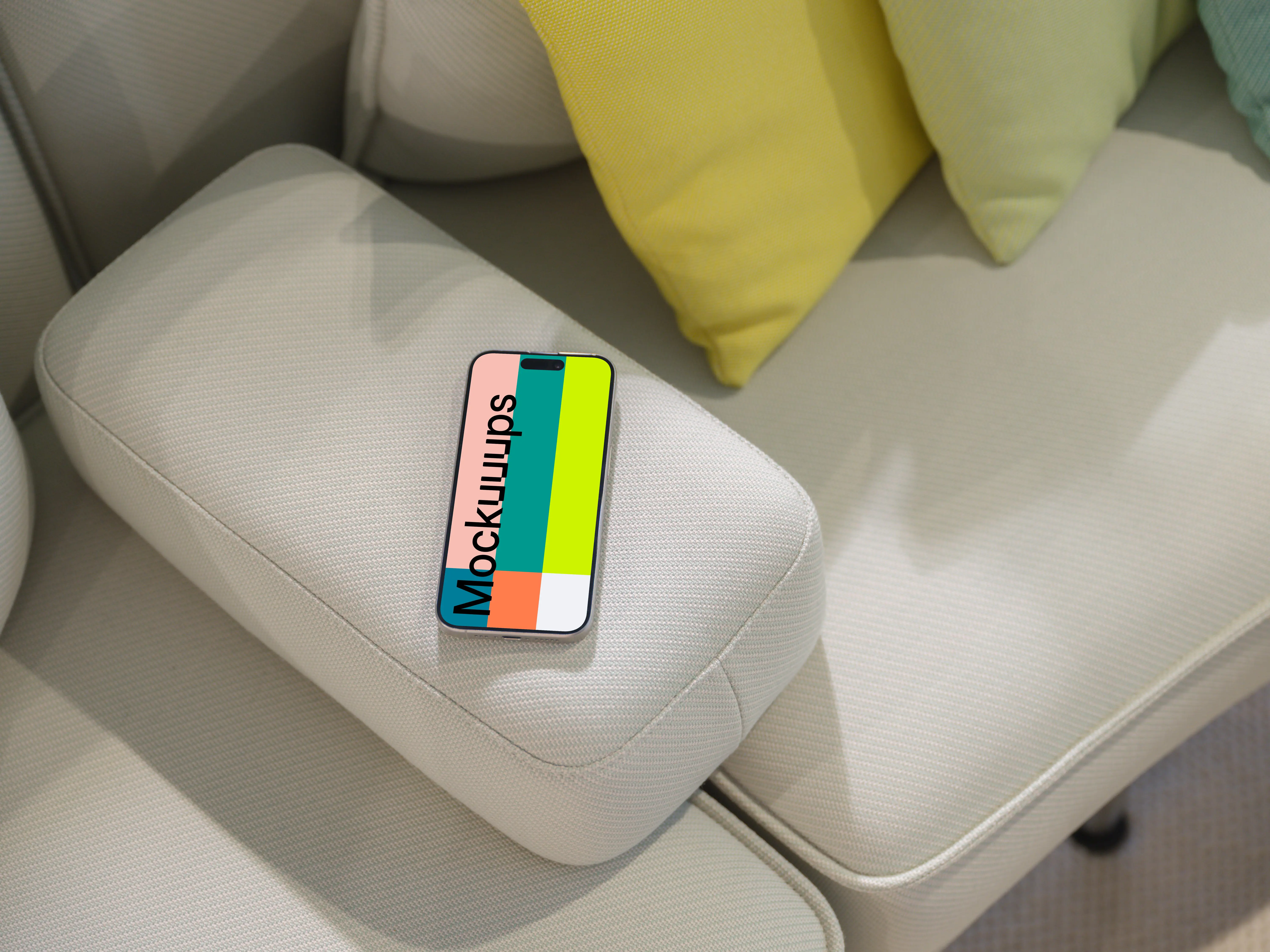 iPhone 15 Pro mockup on modern couch with colorful cushions