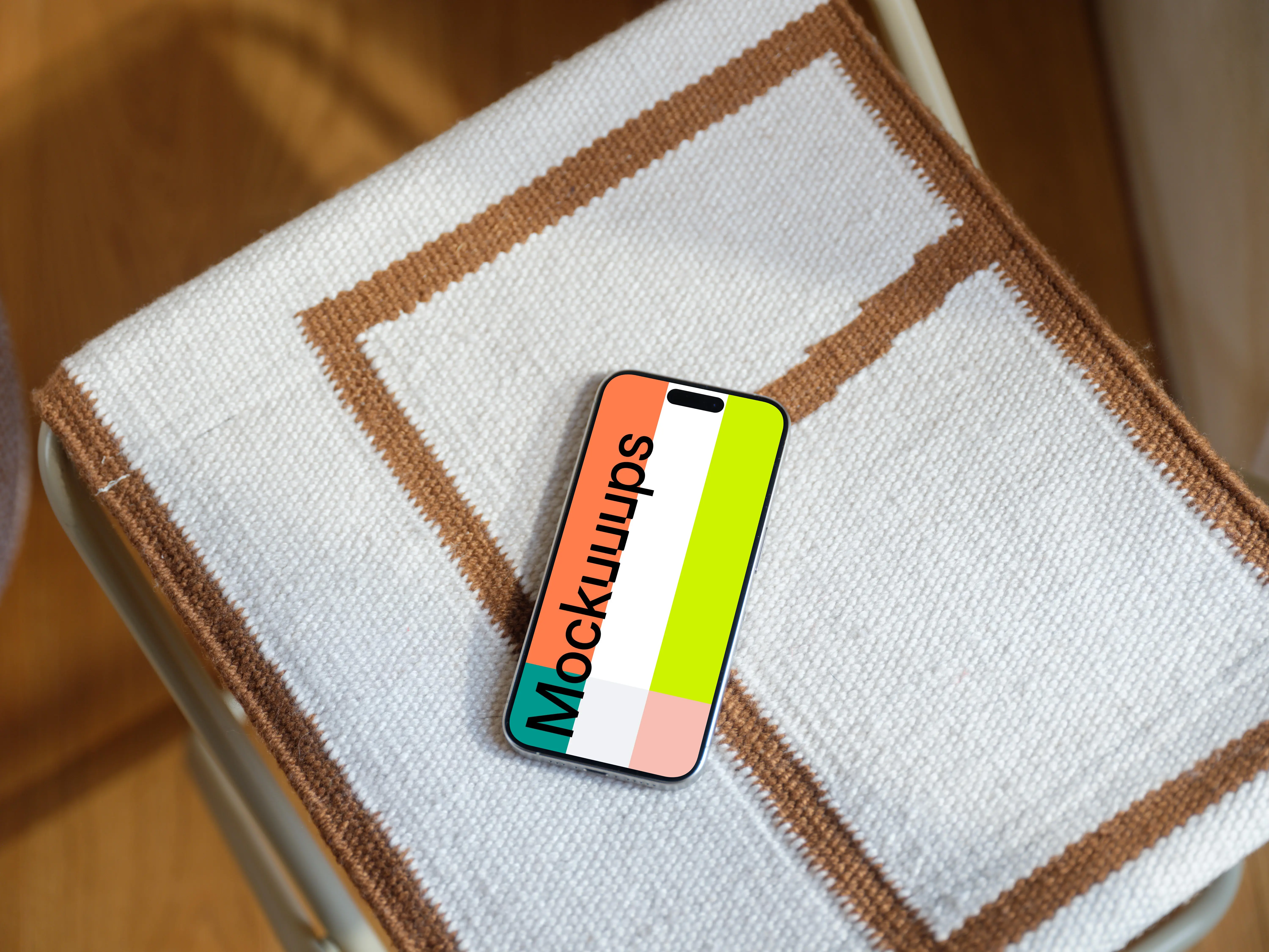 iPhone 15 Pro mockup on textured fabric chair