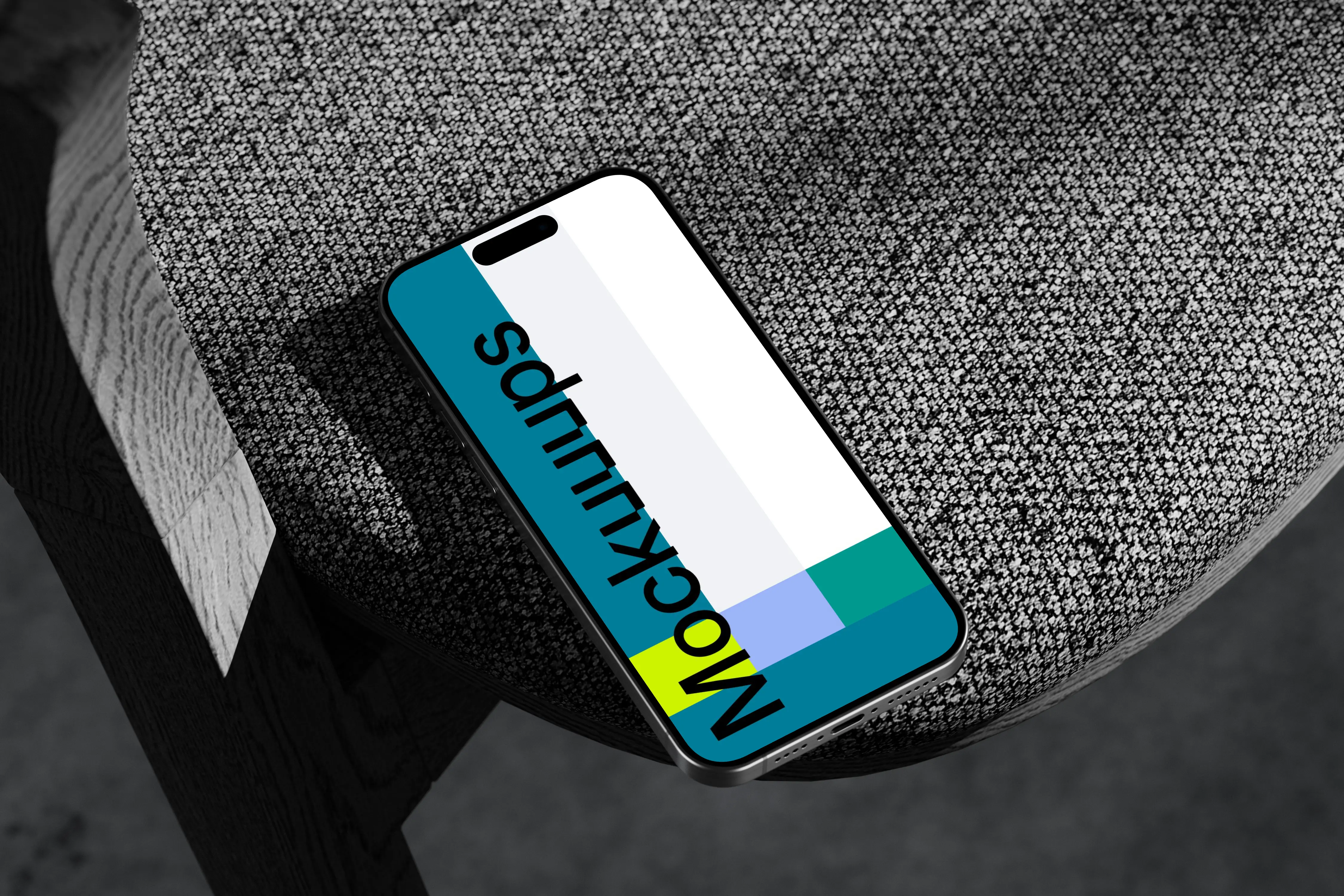 iPhone 15 Pro mockup on textured rock surface with dramatic lighting