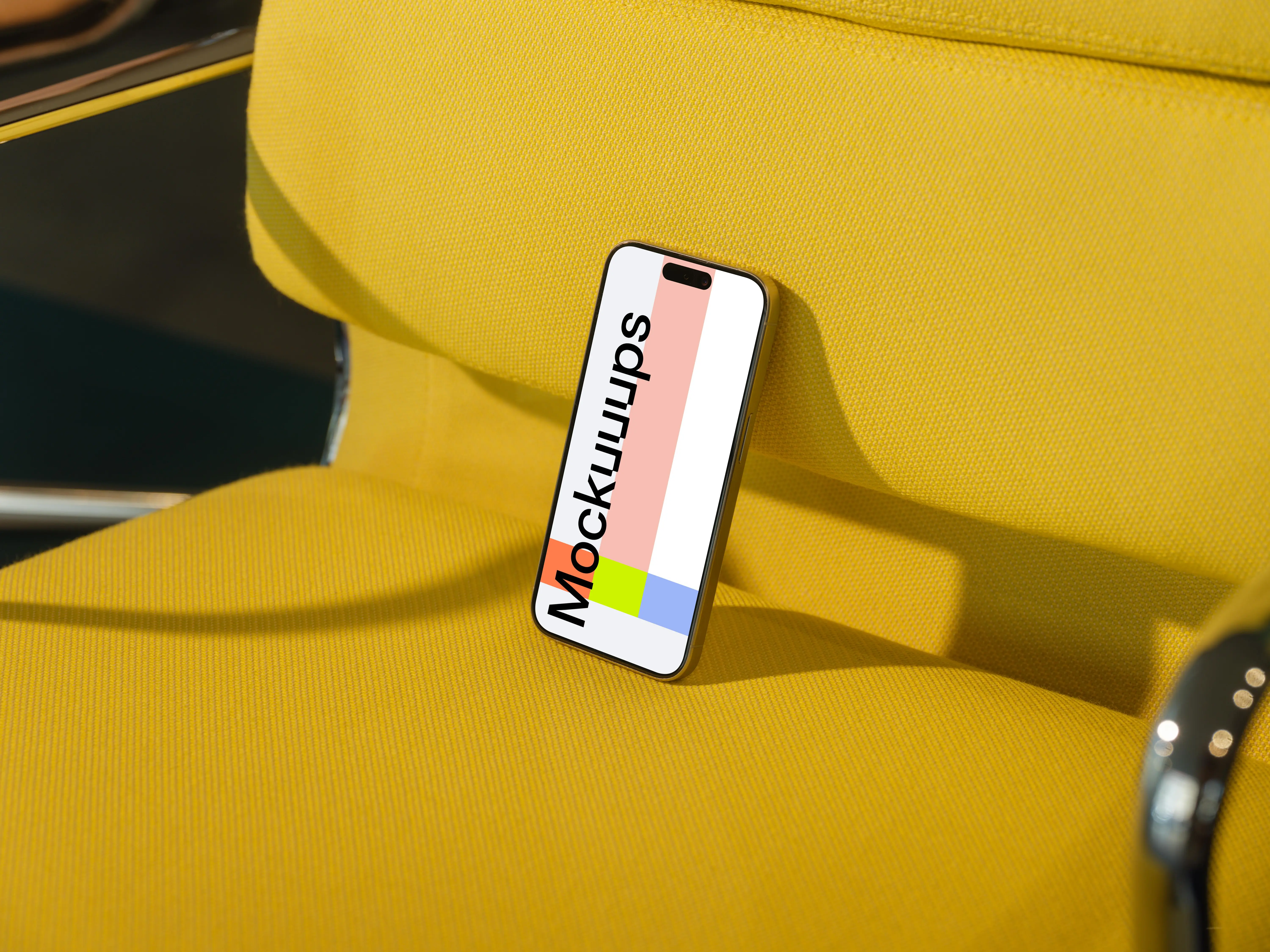 iPhone 15 Pro mockup on yellow armchair