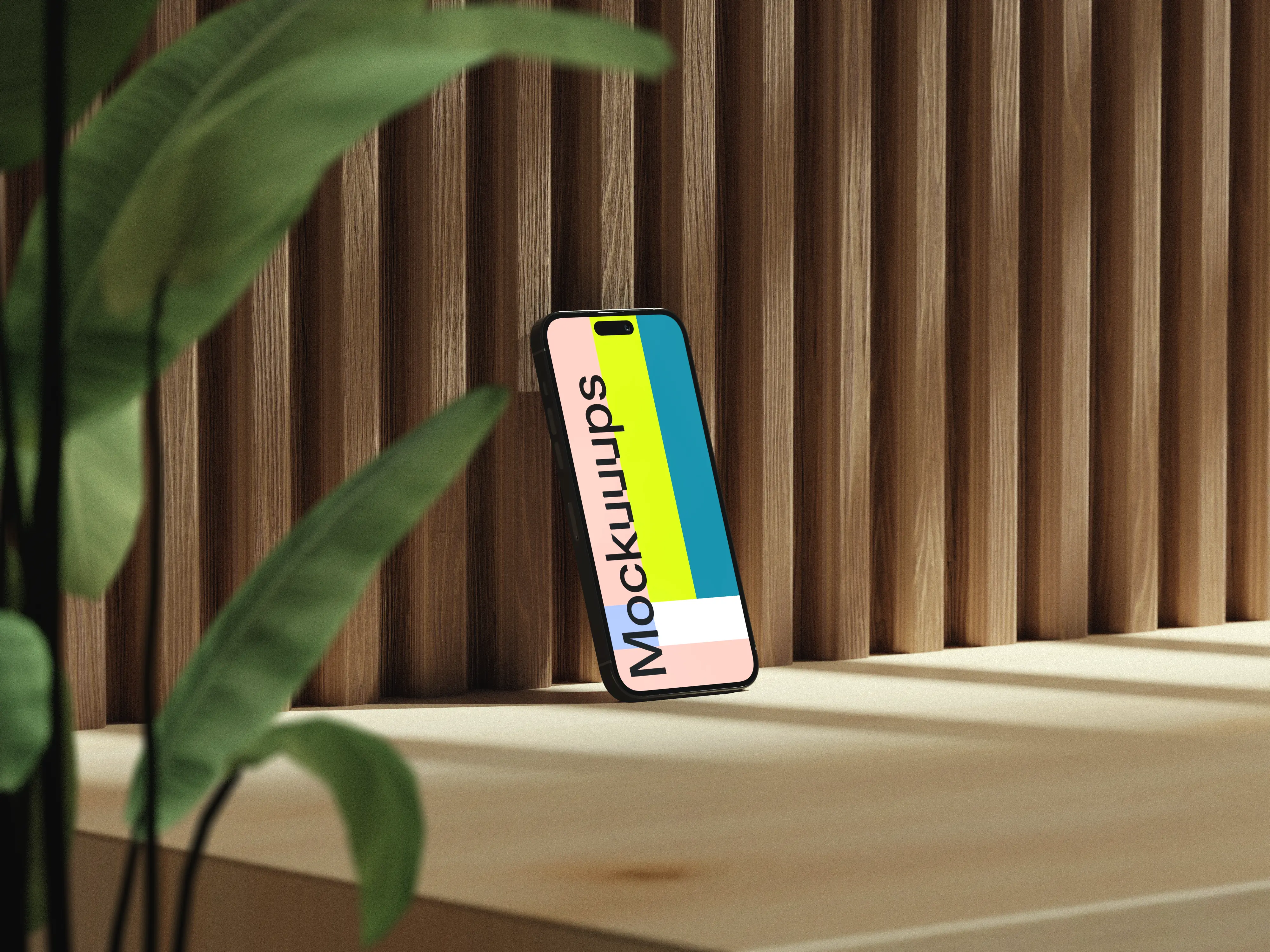 iPhone mockup on a wooden surface with a plant