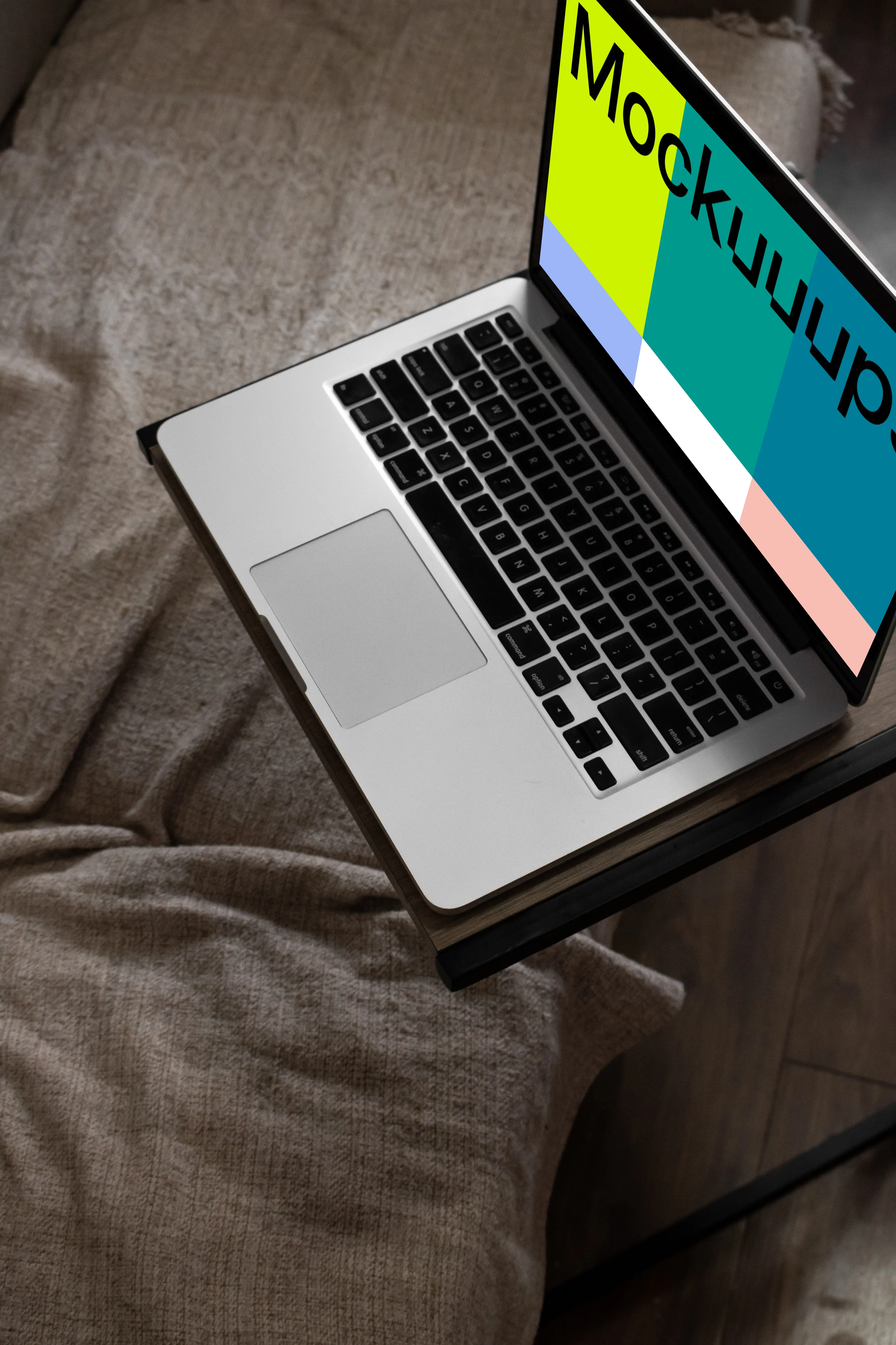 MacBook mockup on bed