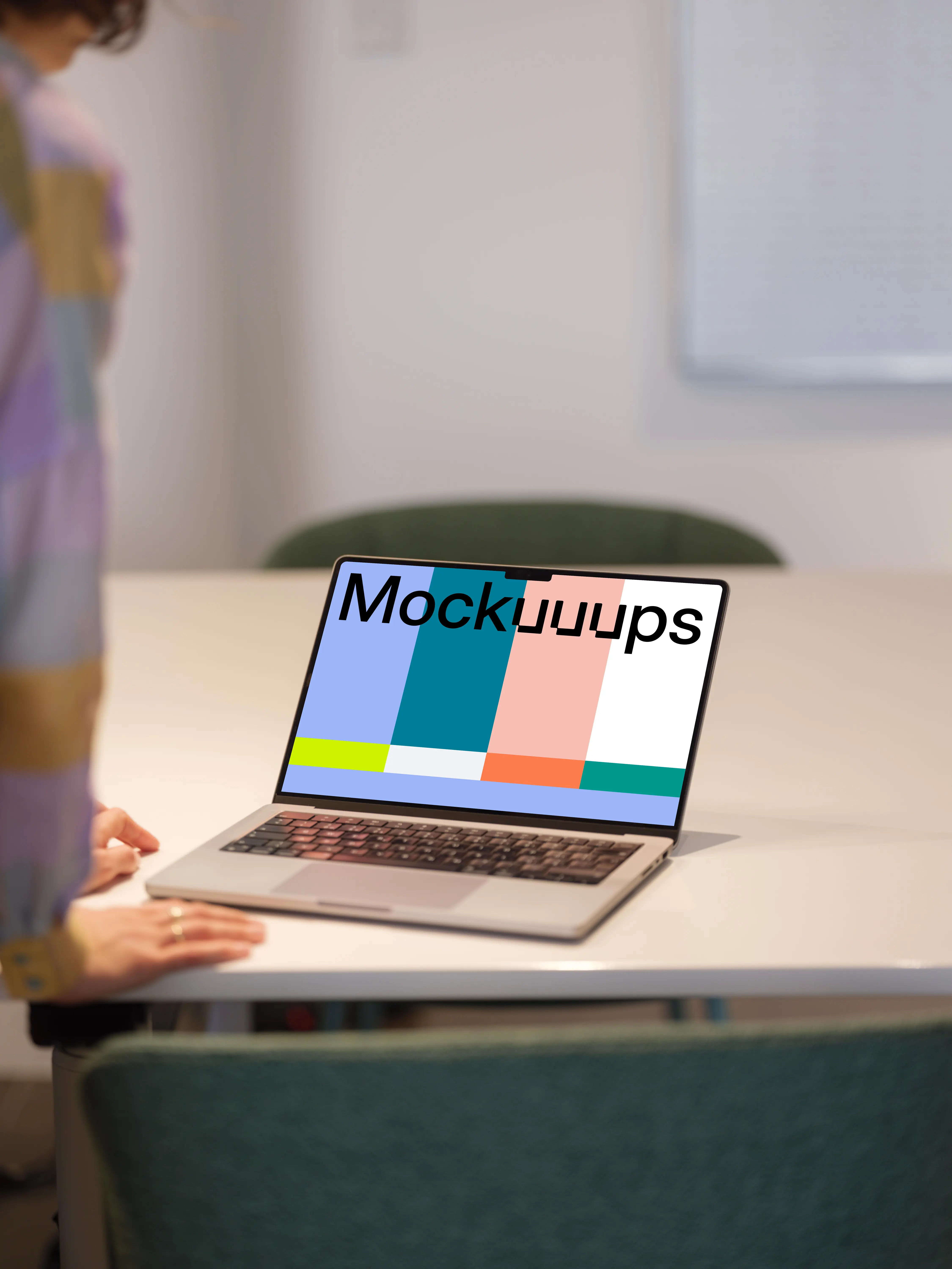 MacBook Pro Mockup on Office Desk with Person in Background