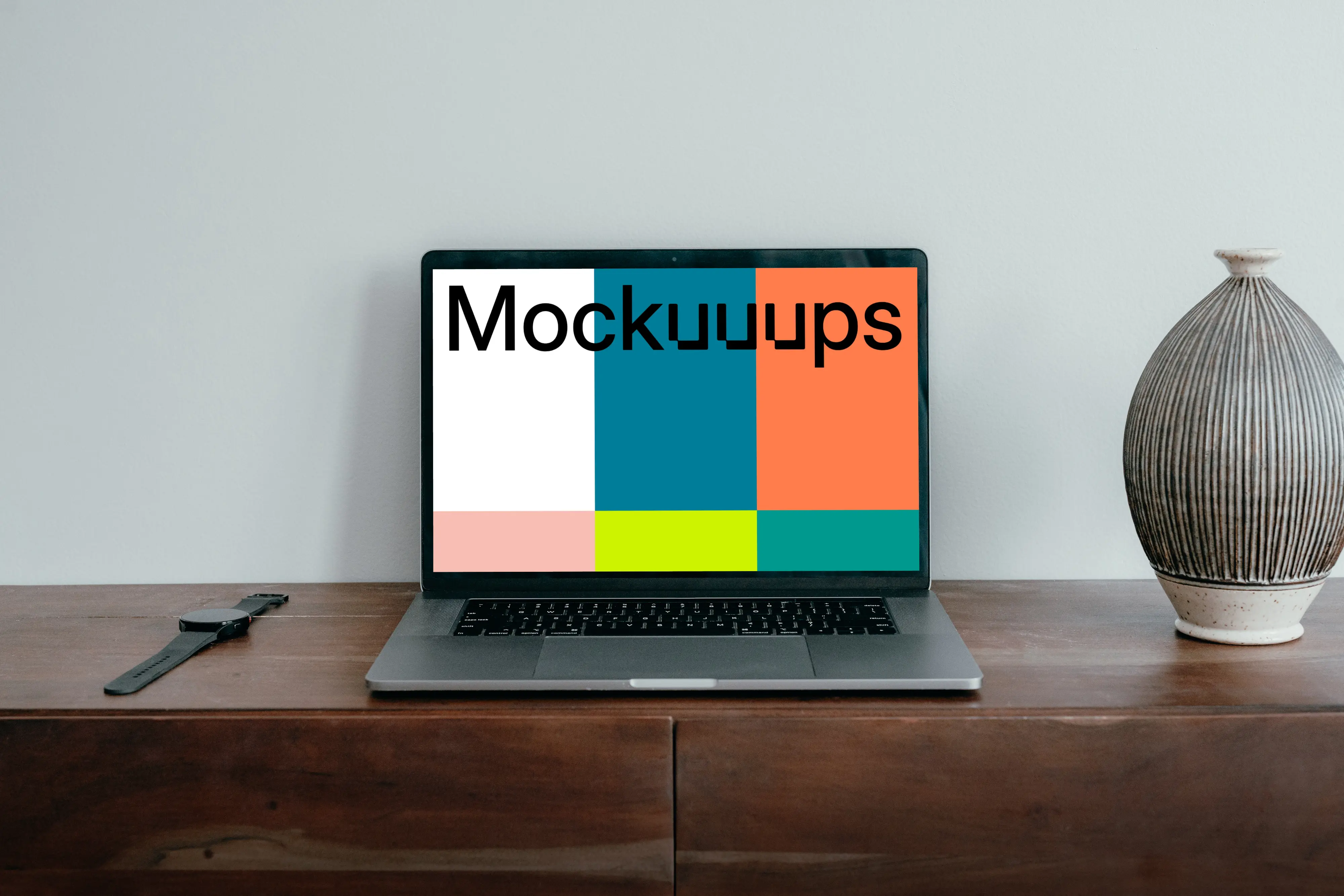 MacBook Pro mockup placed next to a vase and a knife