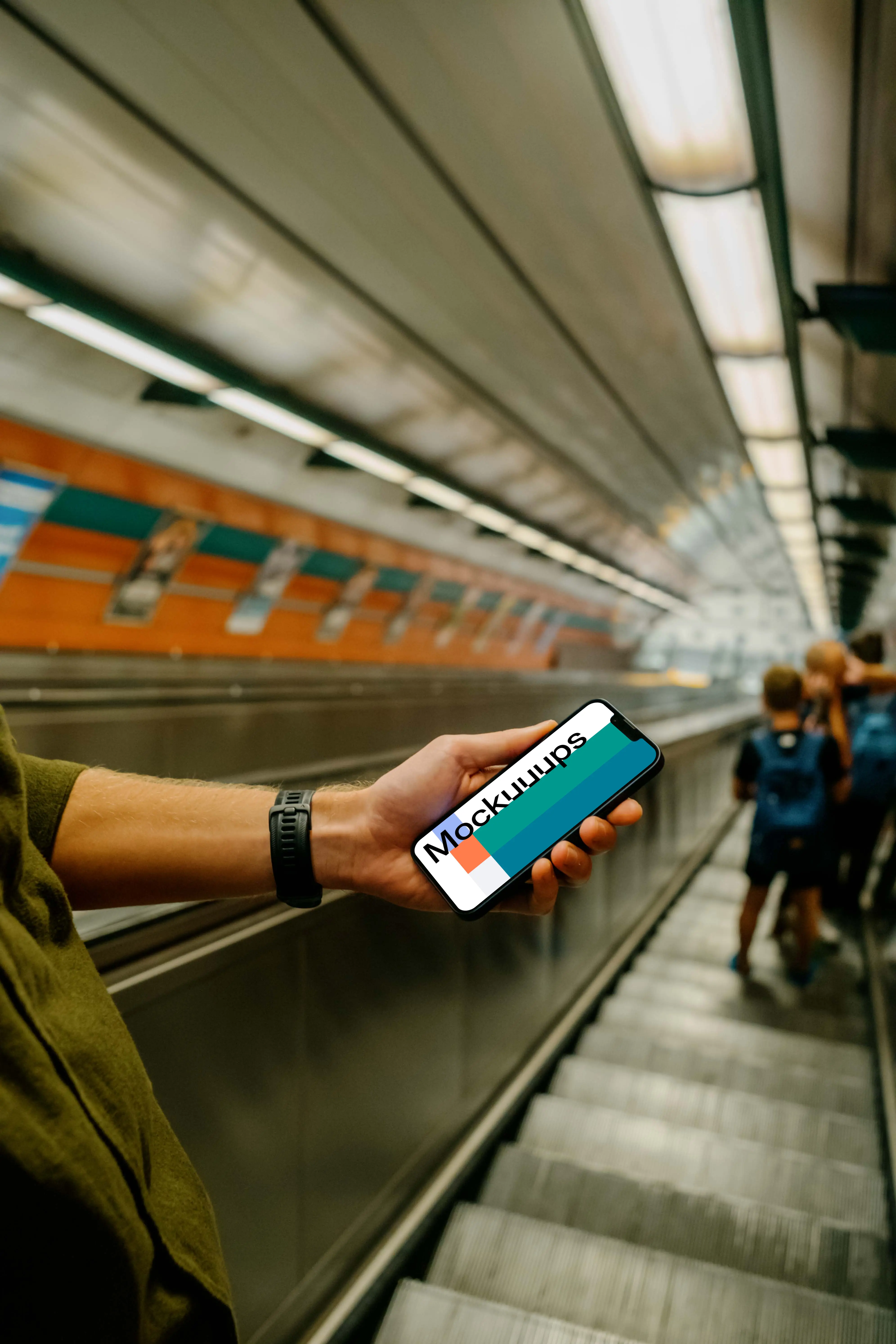 Man holding iPhone 13 mockup in subway