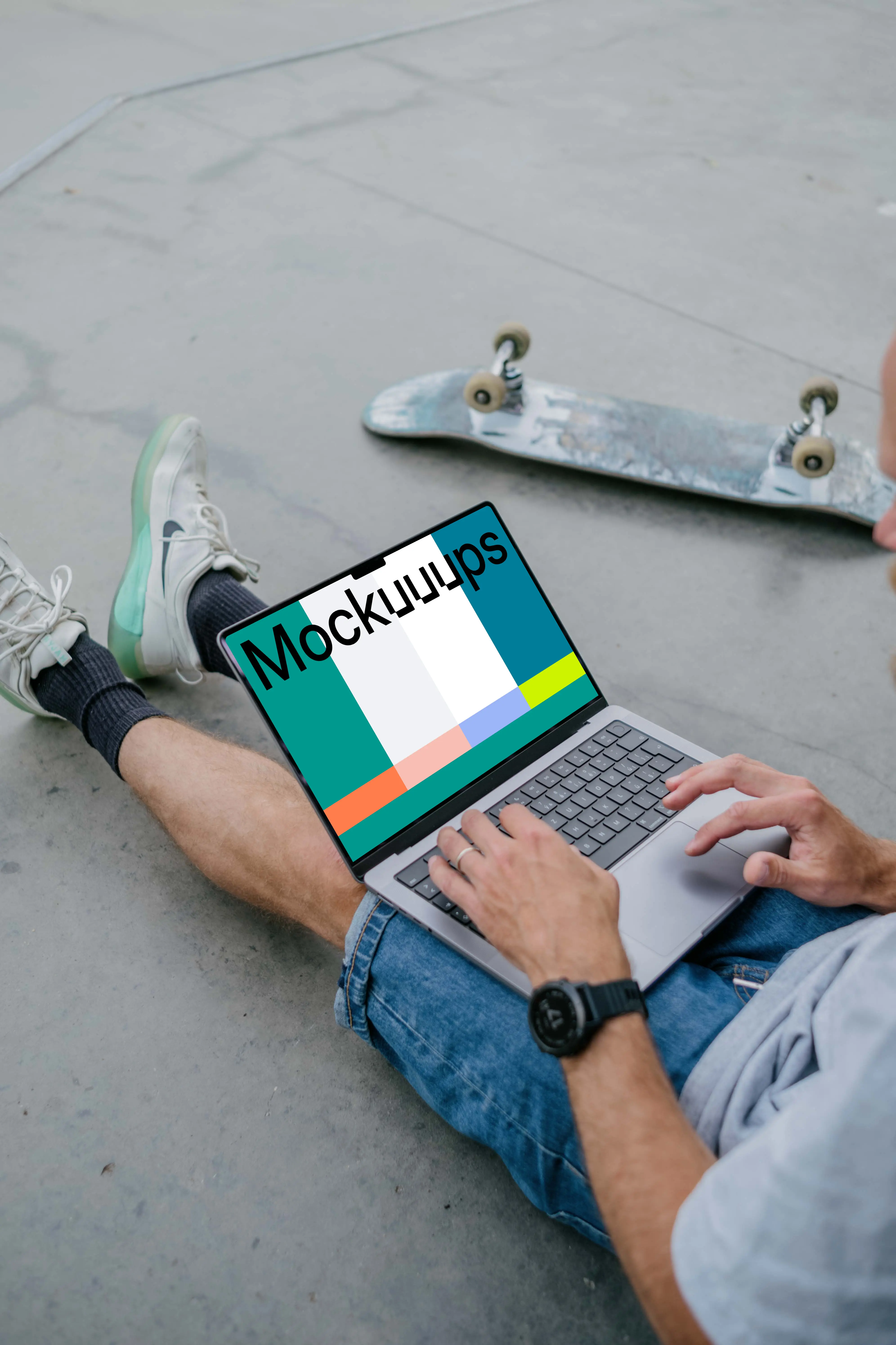 Man typing on a MacBook Pro 14 mockup with skateboard