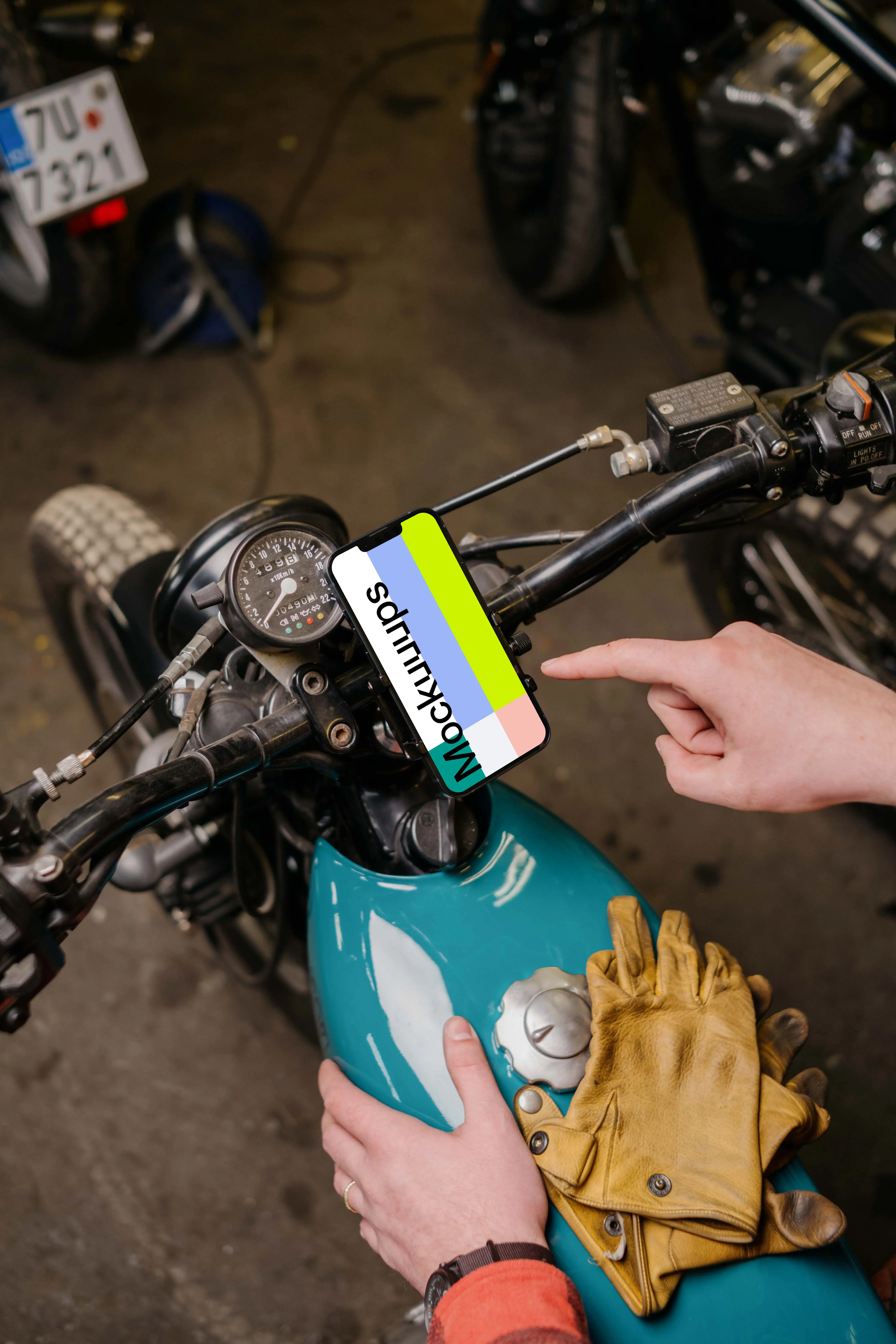 Motorcycle rider using an iPhone 13 Pro mockup 