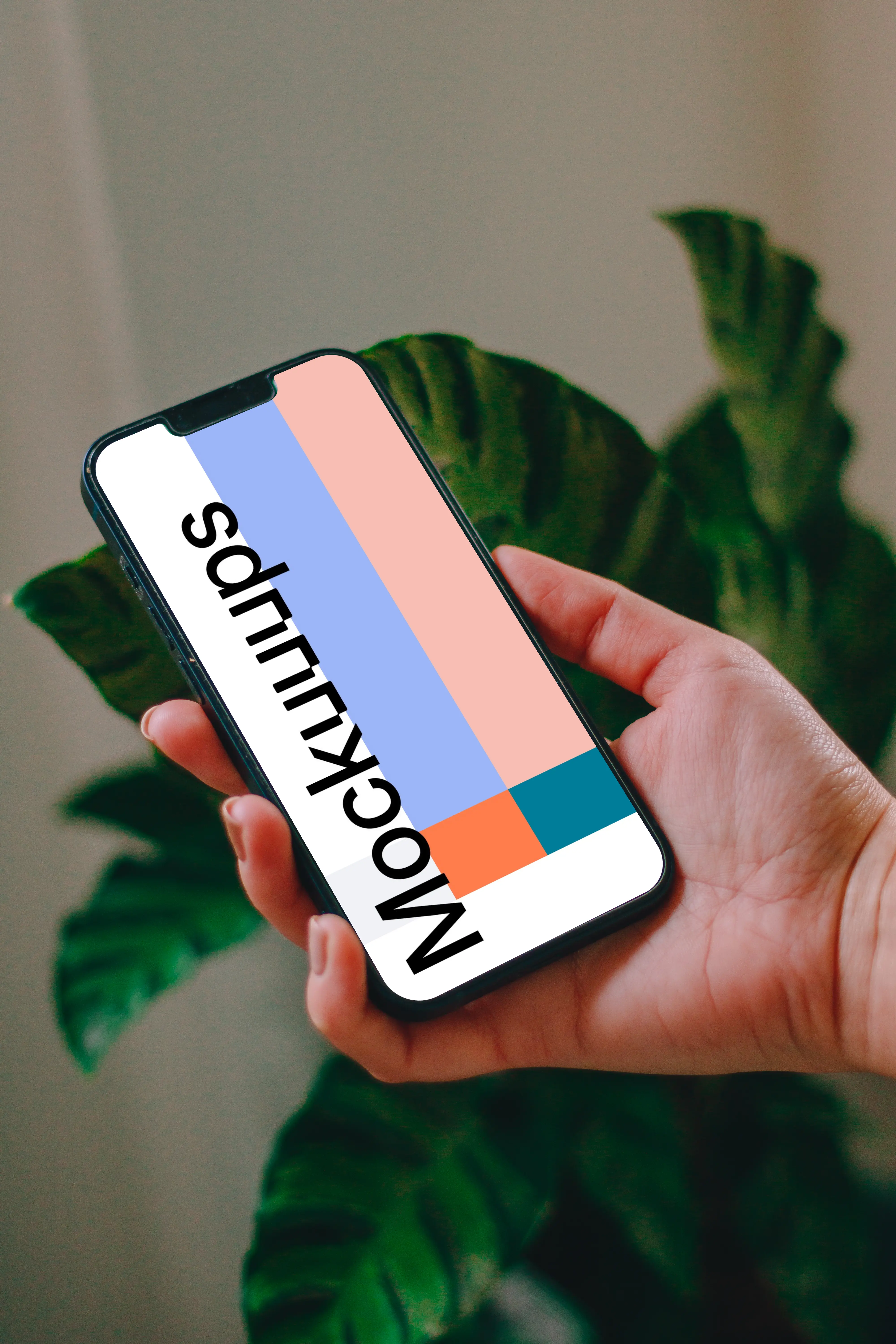 Person holding an iPhone 13 mockup