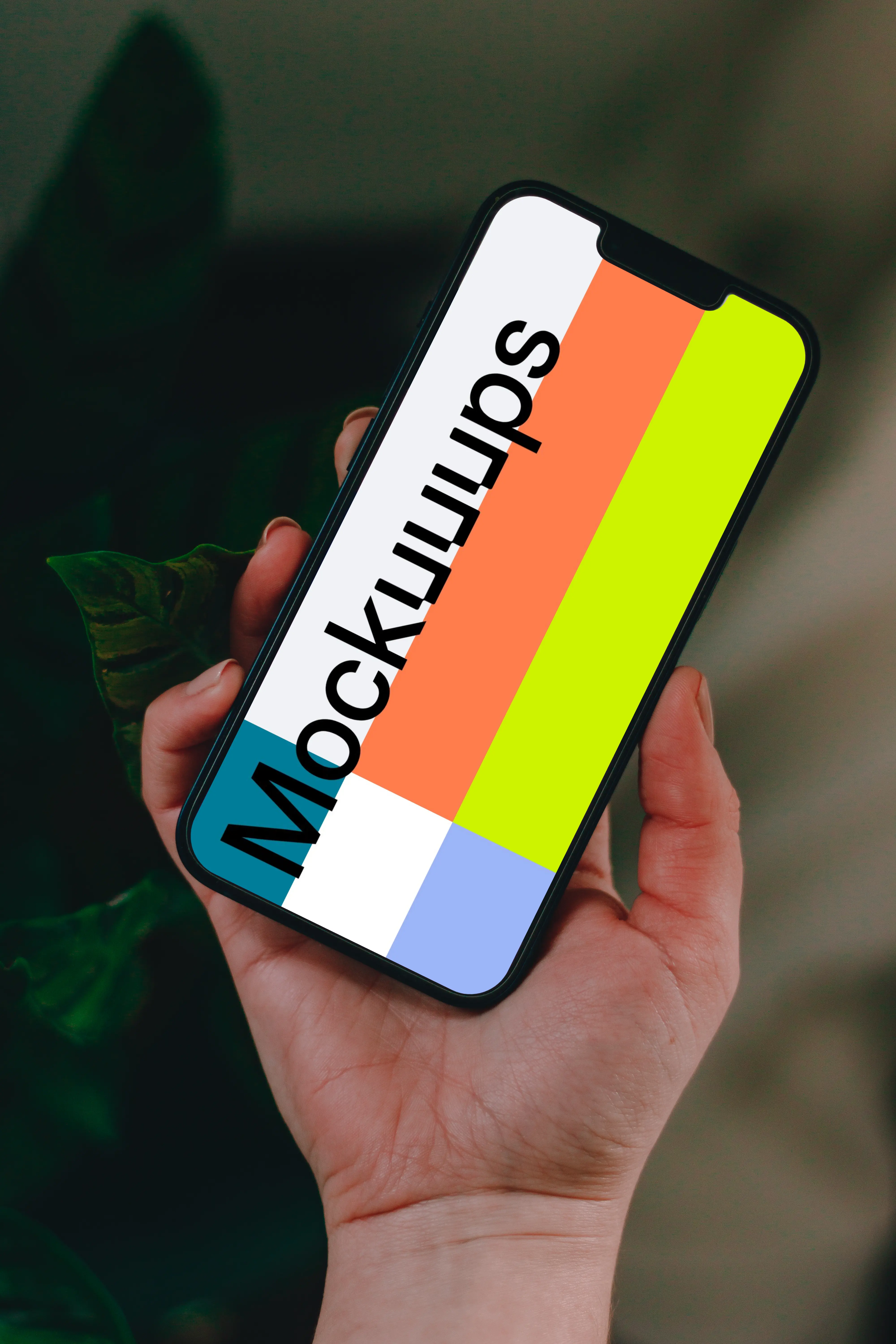 Person holding up an iPhone 13 mockup