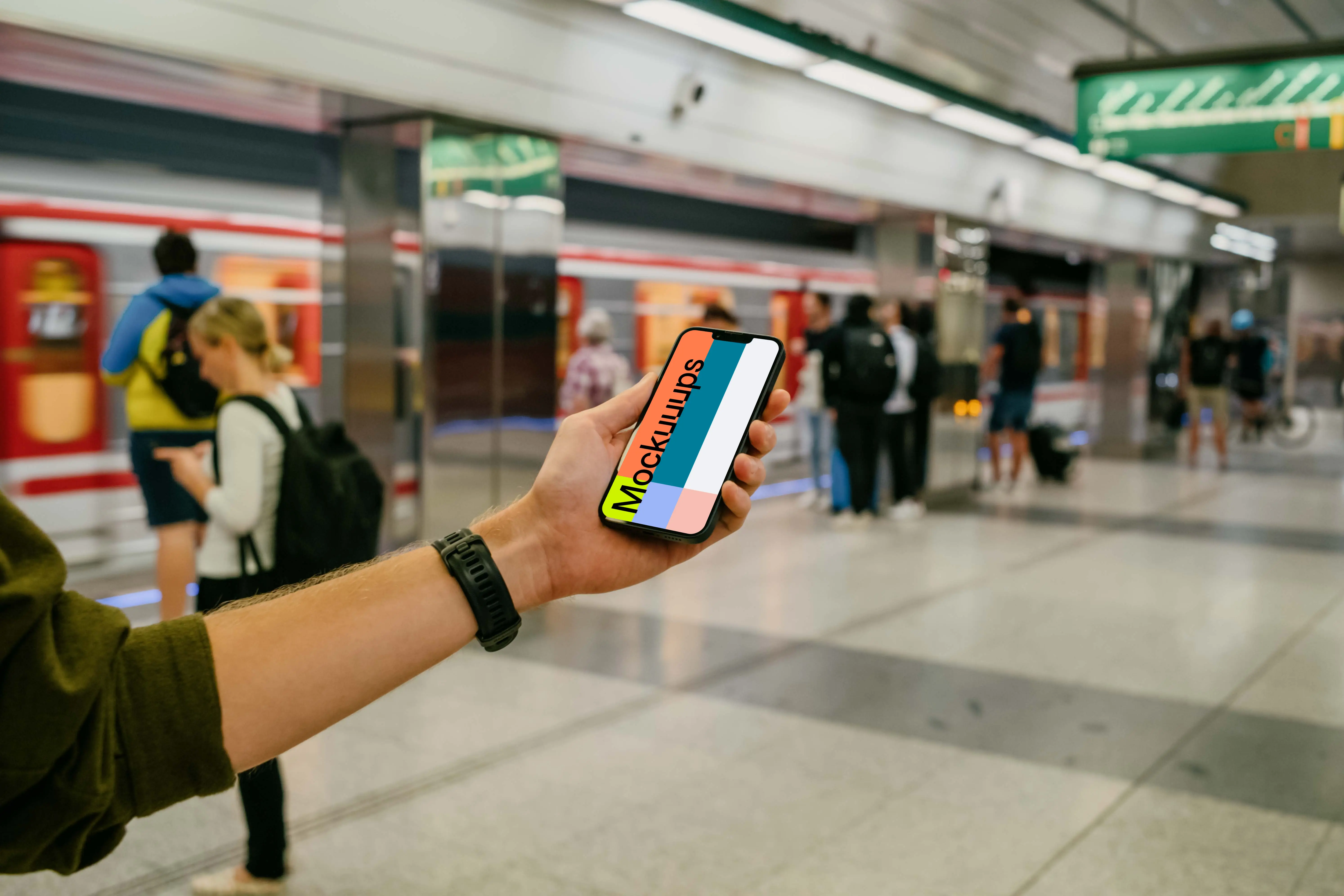 Person's hand holding an iPhone 13 mockup